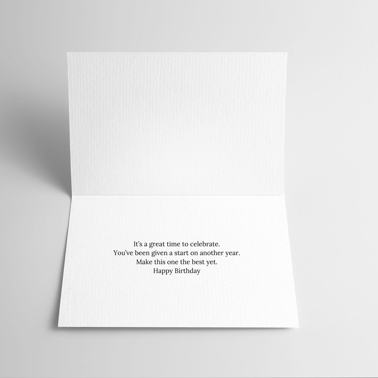 White greeting card with black text on a light gray background
