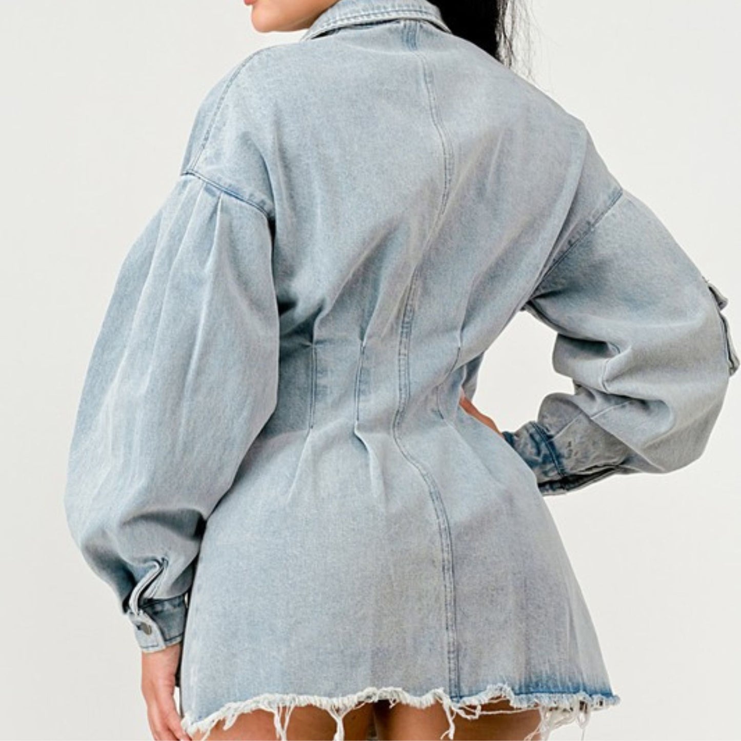 Light blue denim jacket worn by a person on a white background