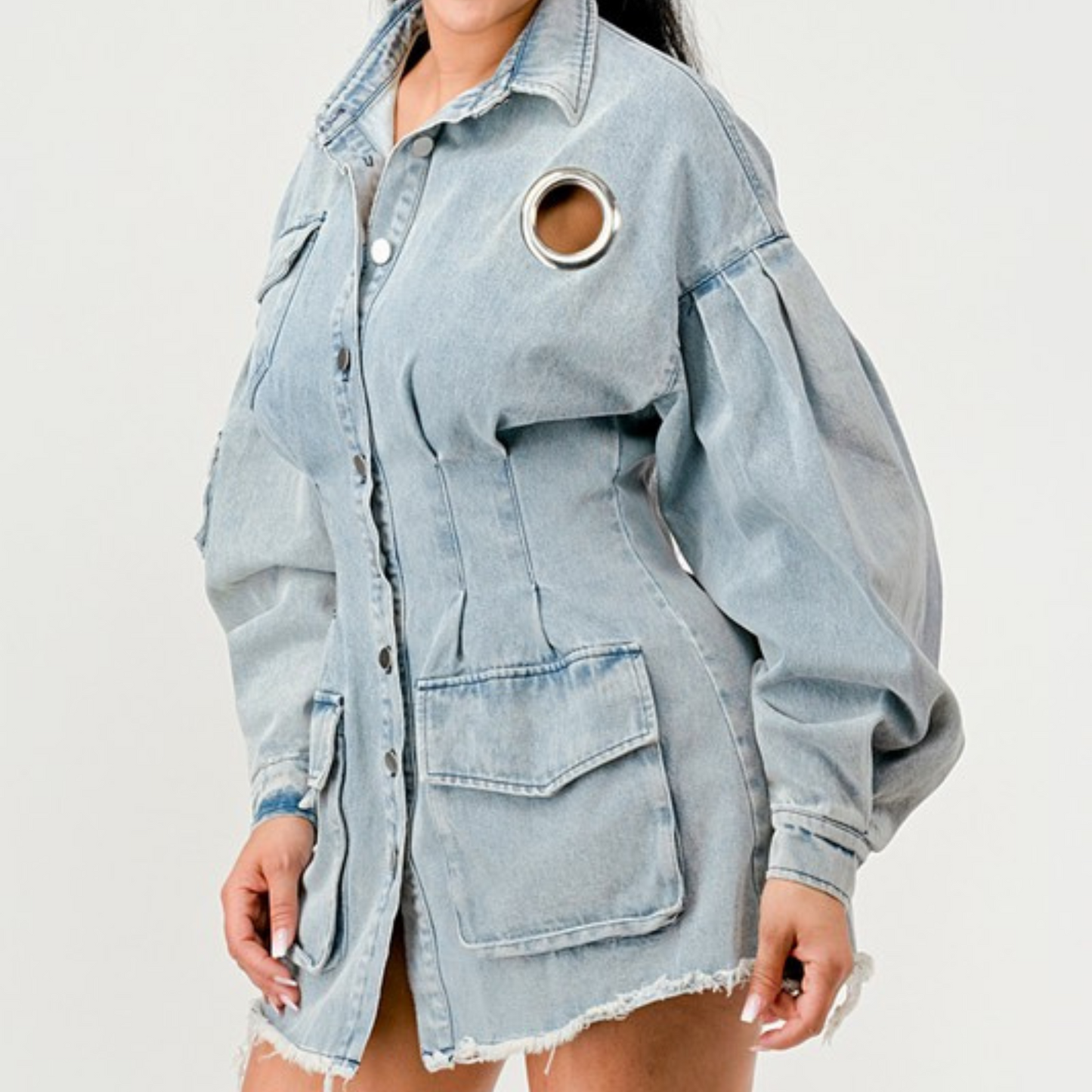 Light blue denim jacket with a circular cutout on a white background