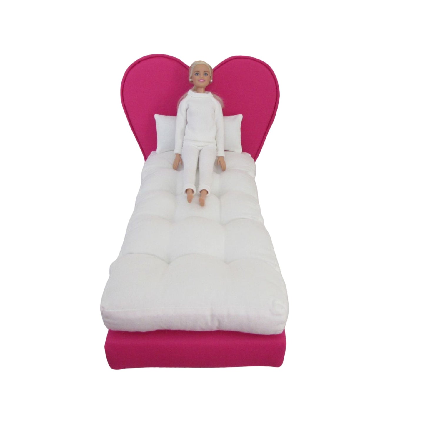 Doll sitting on hot pink heart doll bed for 11.5-inch and 12-inch dolls
