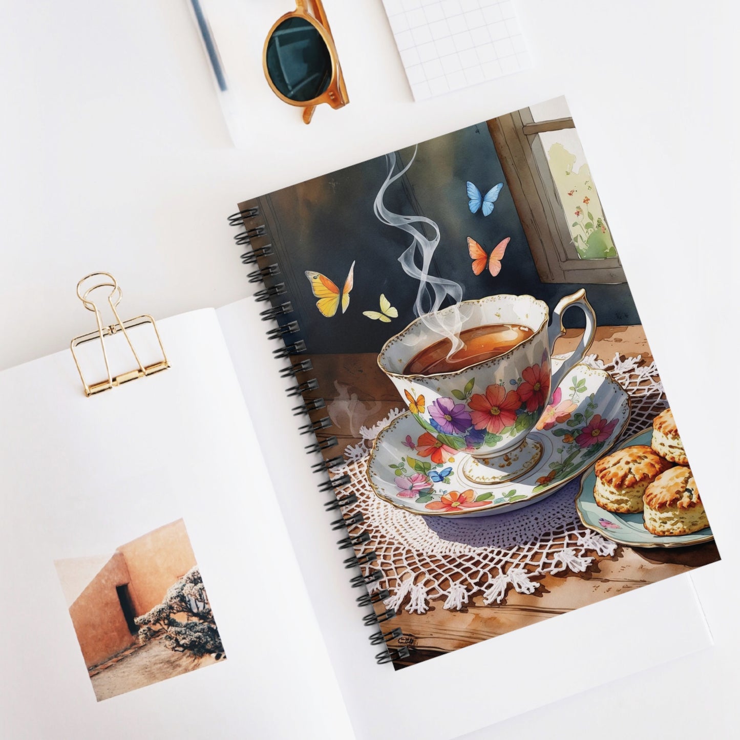 Notebook with a floral teacup design on a white surface