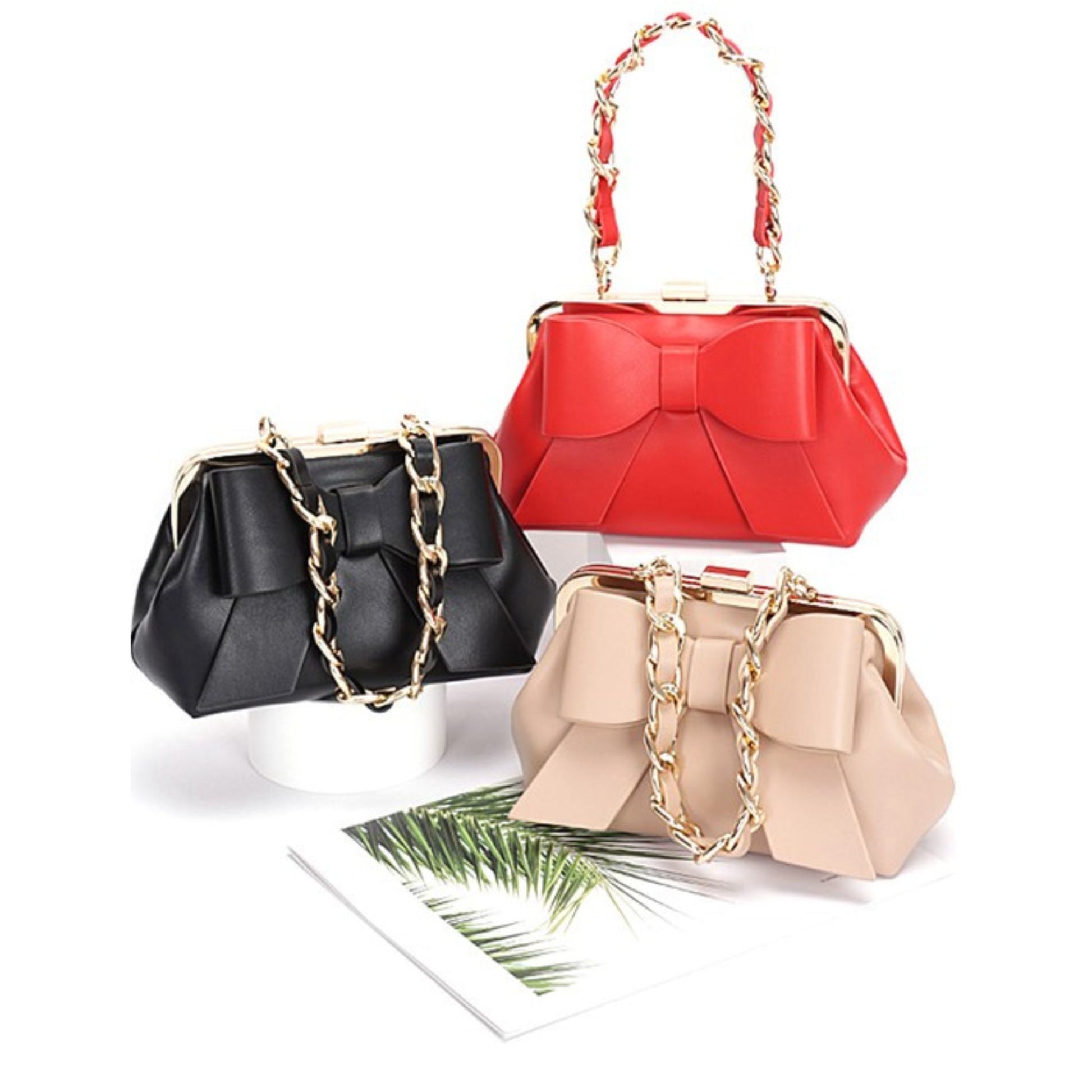 Three handbags in black, red, and beige with gold chains on a white background.
