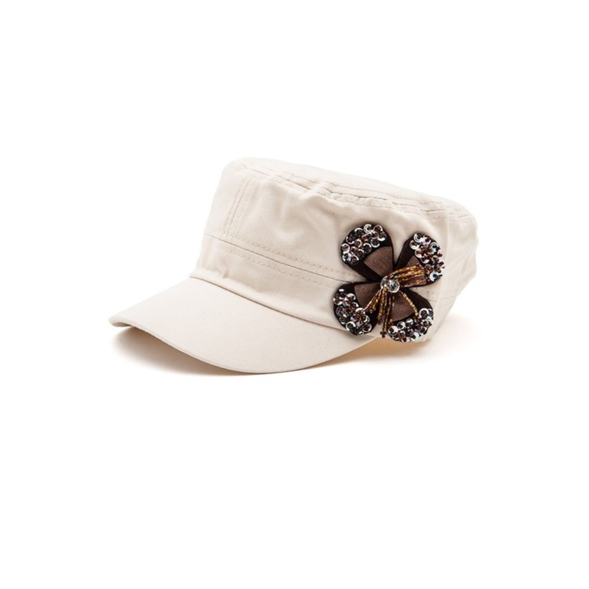 Beige cap with a decorative brooch on a white background