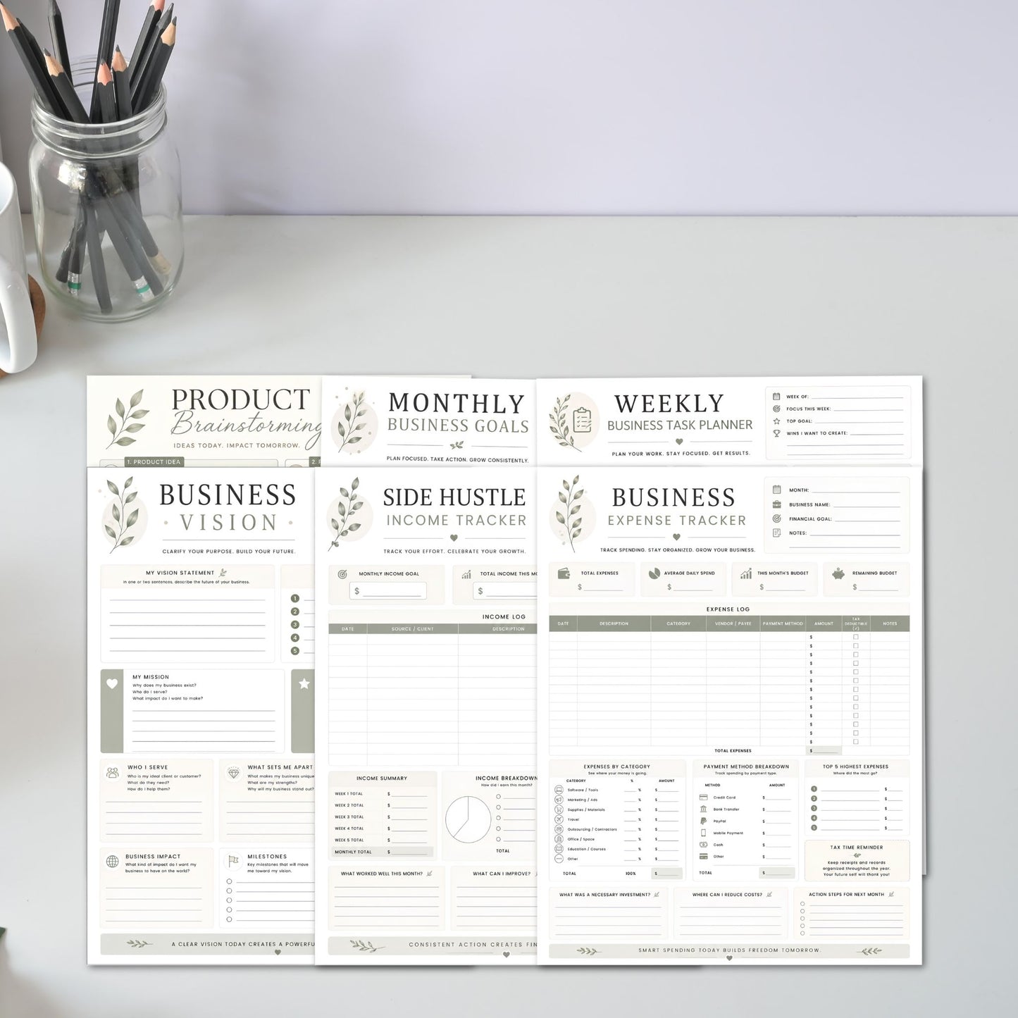 Sheet of business planning forms on a desk with office supplies.