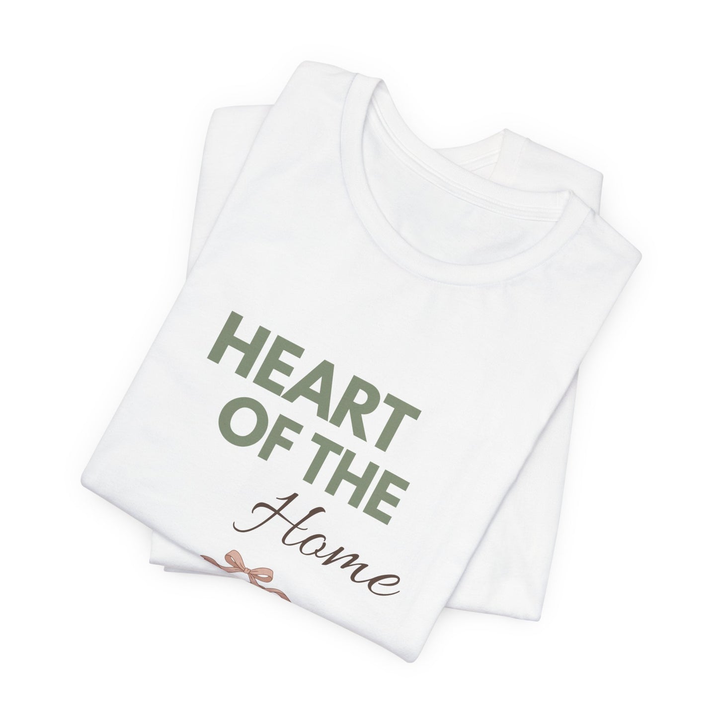 A folded white t-shirt with 'HEART OF THE Home' on the front.