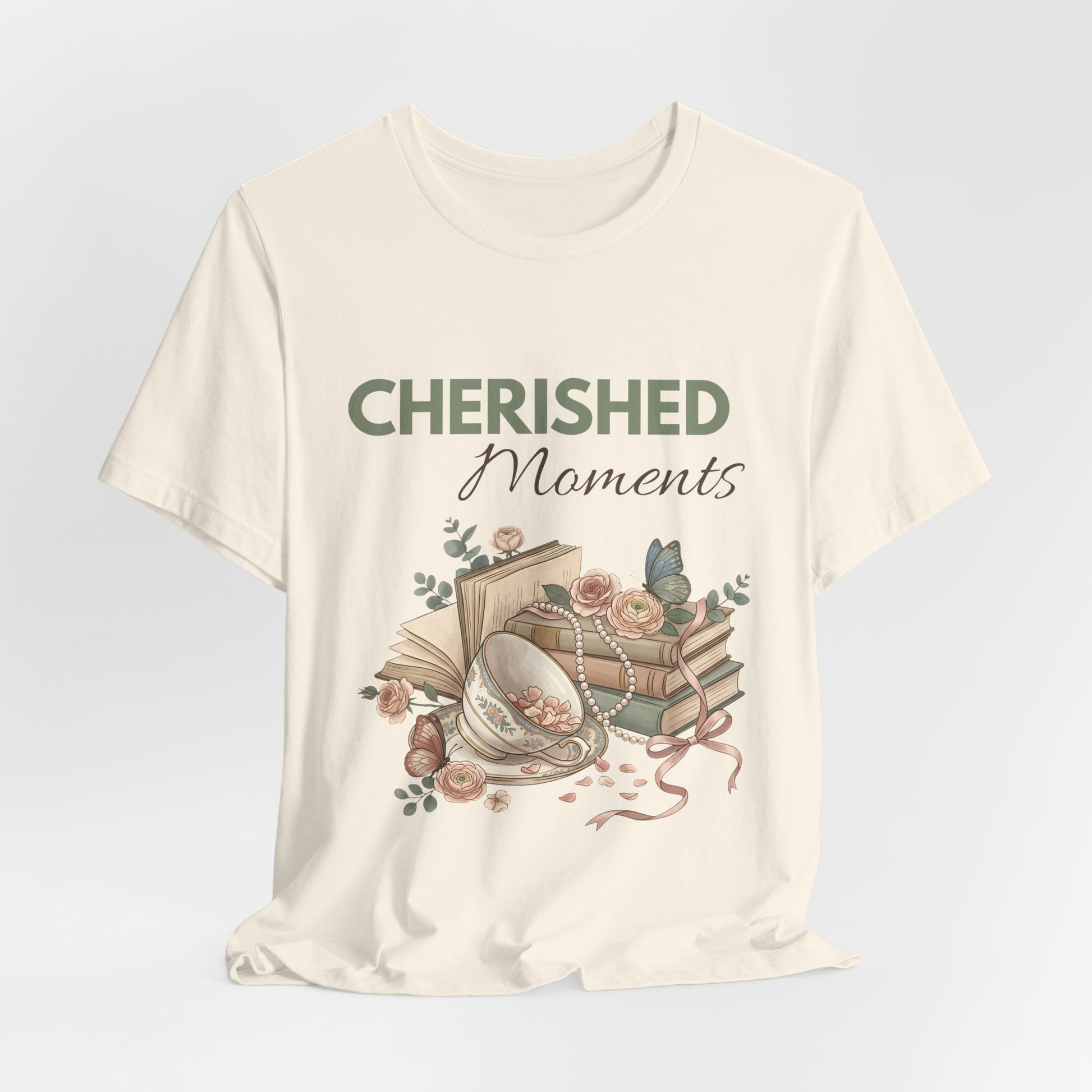A hanging natural colored t-shirt with 'CHERISHED Moments' on the front.