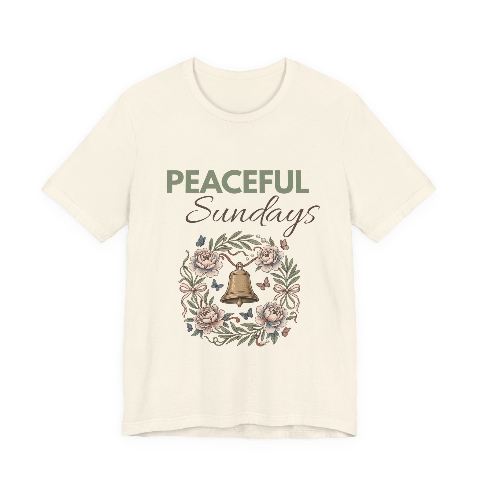 A natural colored t-shirt with 'Peaceful Sundays' design featuring a bell and flowers on a white background