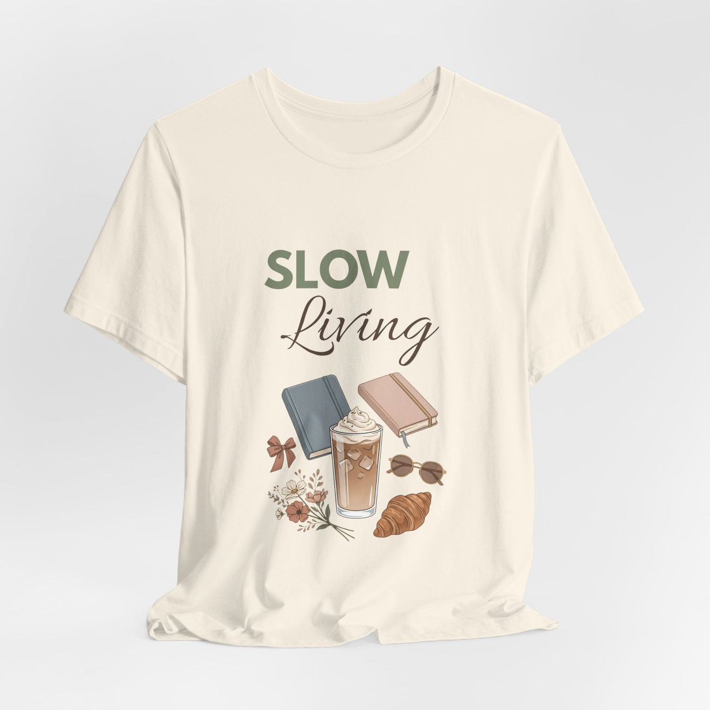 Natural colored t-shirt with 'Slow Living' text and illustrations on a light gray background