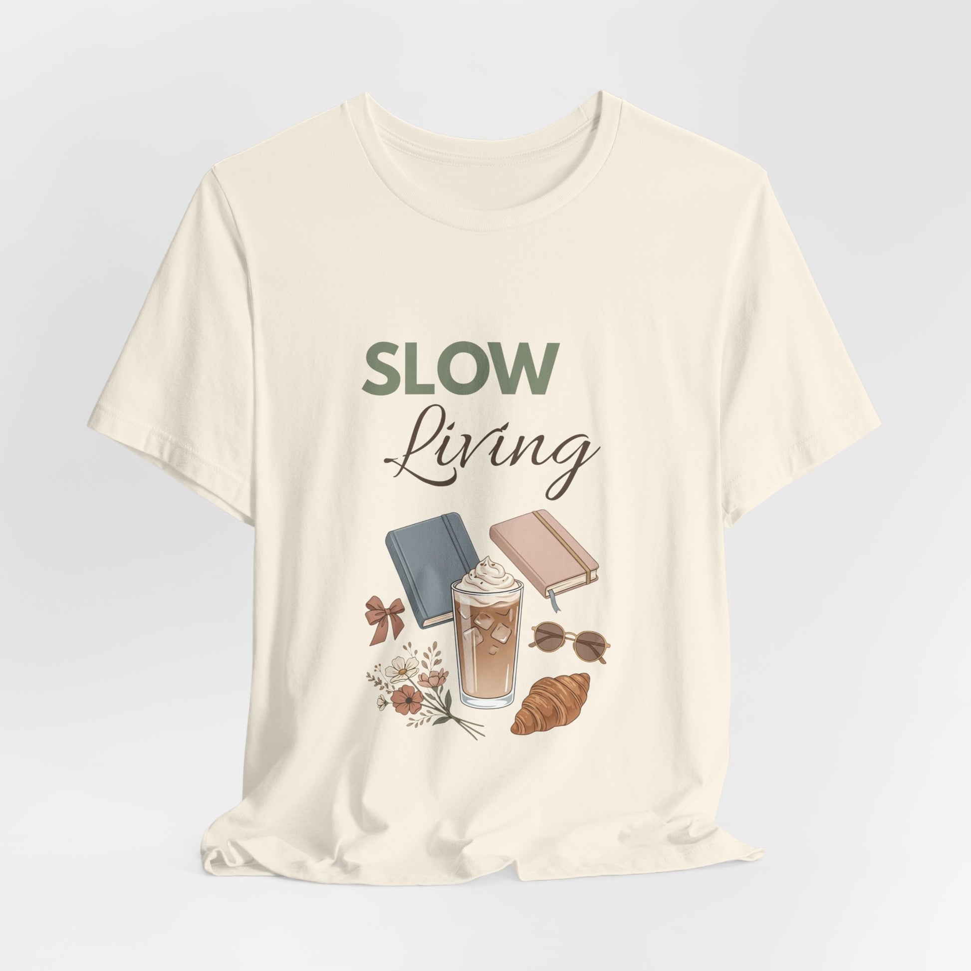Natural colored t-shirt with 'Slow Living' text and illustrations on a light gray background