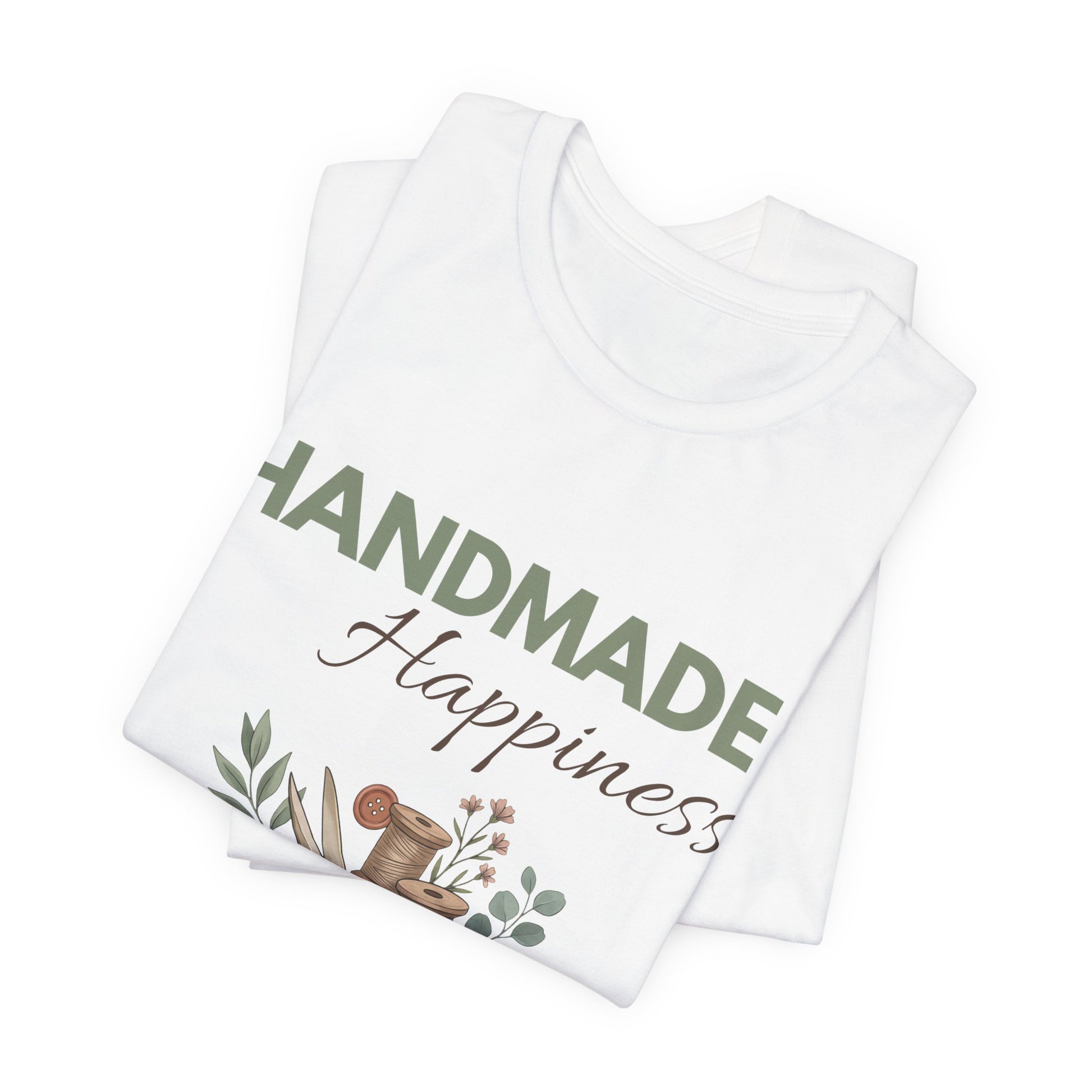 A folded white t-shirt with 'HANDMADE Happiness' on the front.