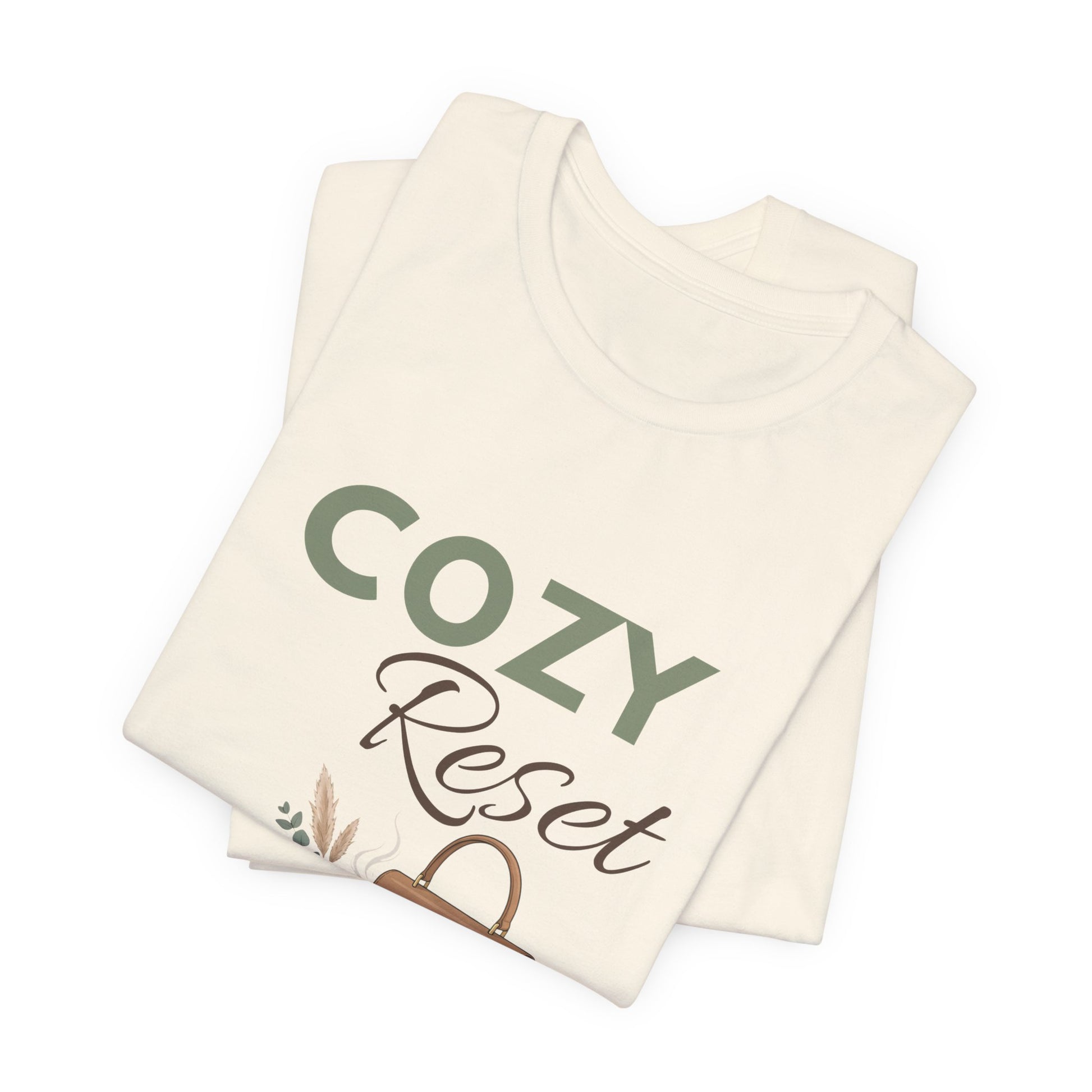 A folded t-shirt with 'COZY Reset' on the front.