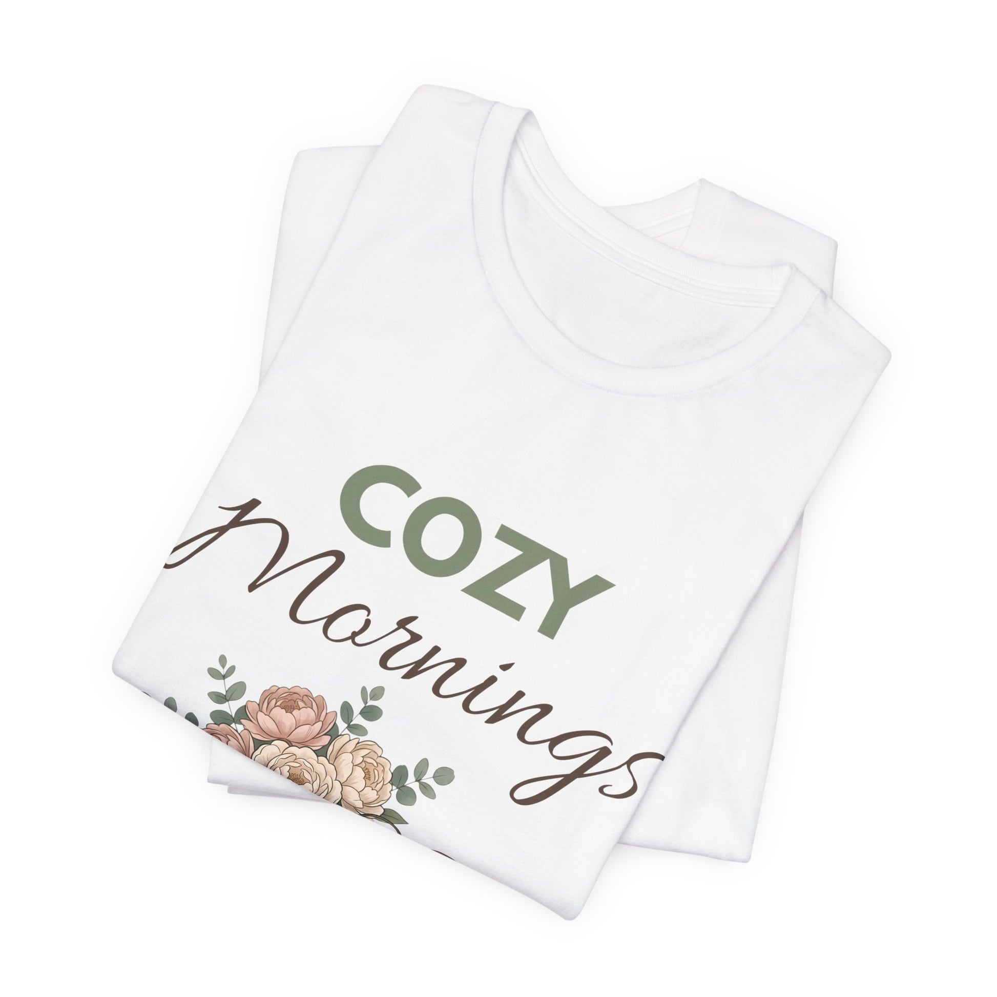 Folded white t-shirt with 'COZY Mornings' text and floral design on a white background