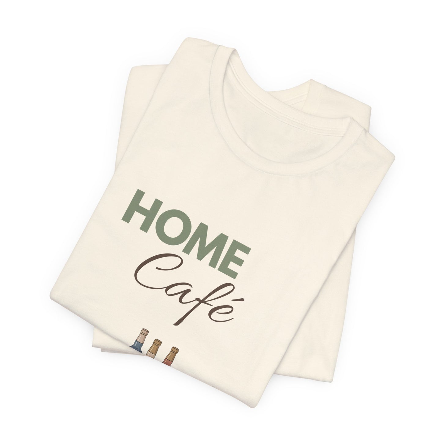 Folded natural colored t-shirt with 'HOME Café' text on a white background