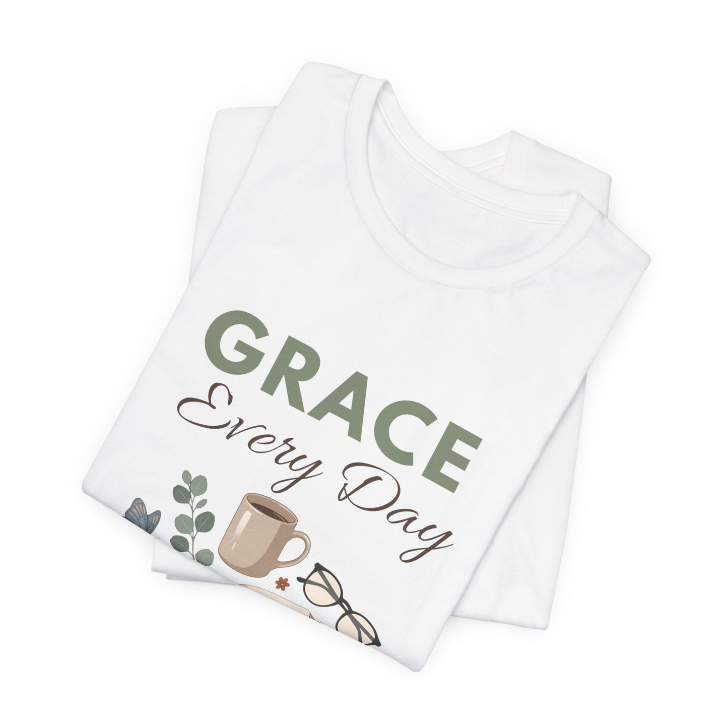 Folded white t-shirt with 'GRACE Every Day' text and coffee cup design on a white background