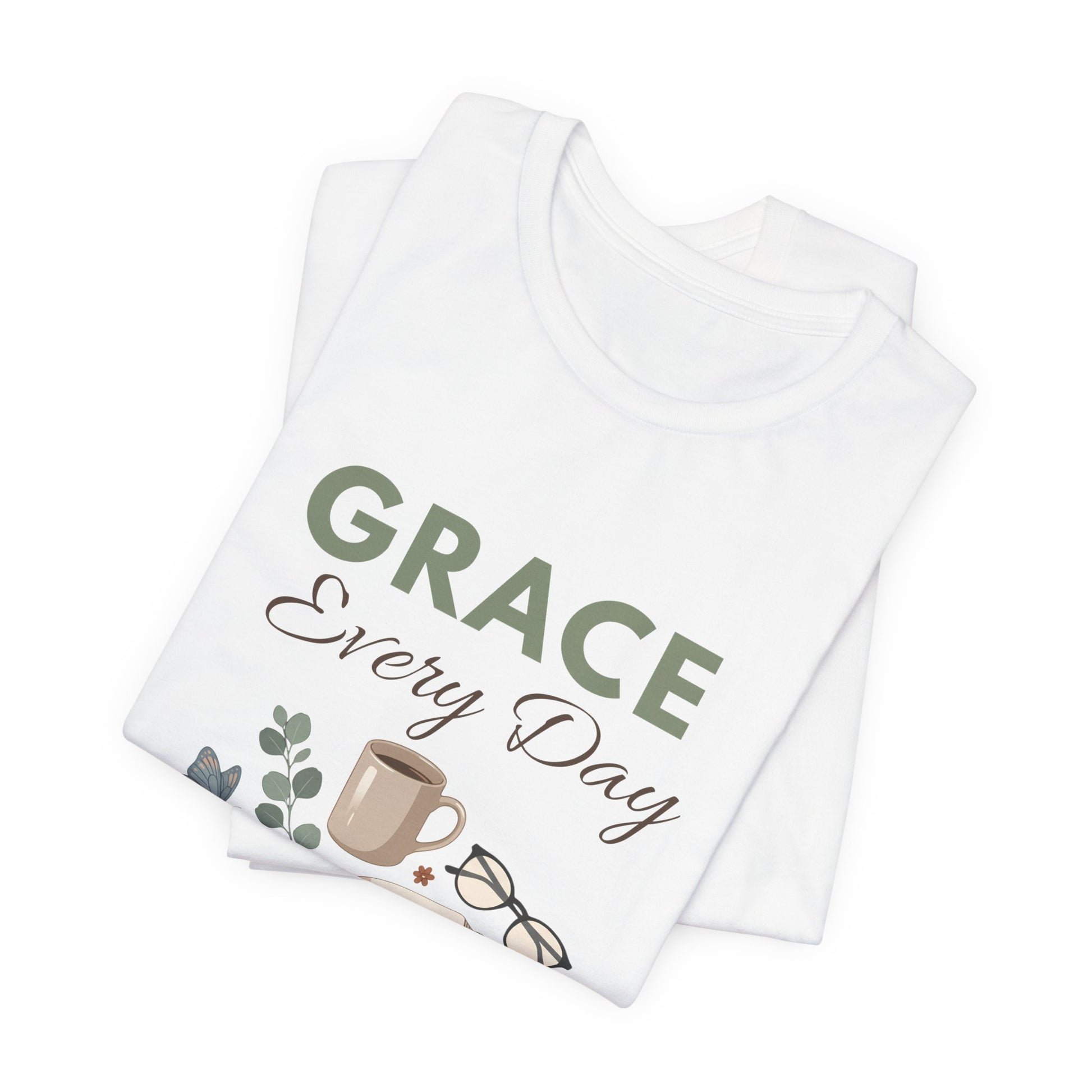 Folded white t-shirt with 'GRACE Every Day' text and coffee cup design on a white background
