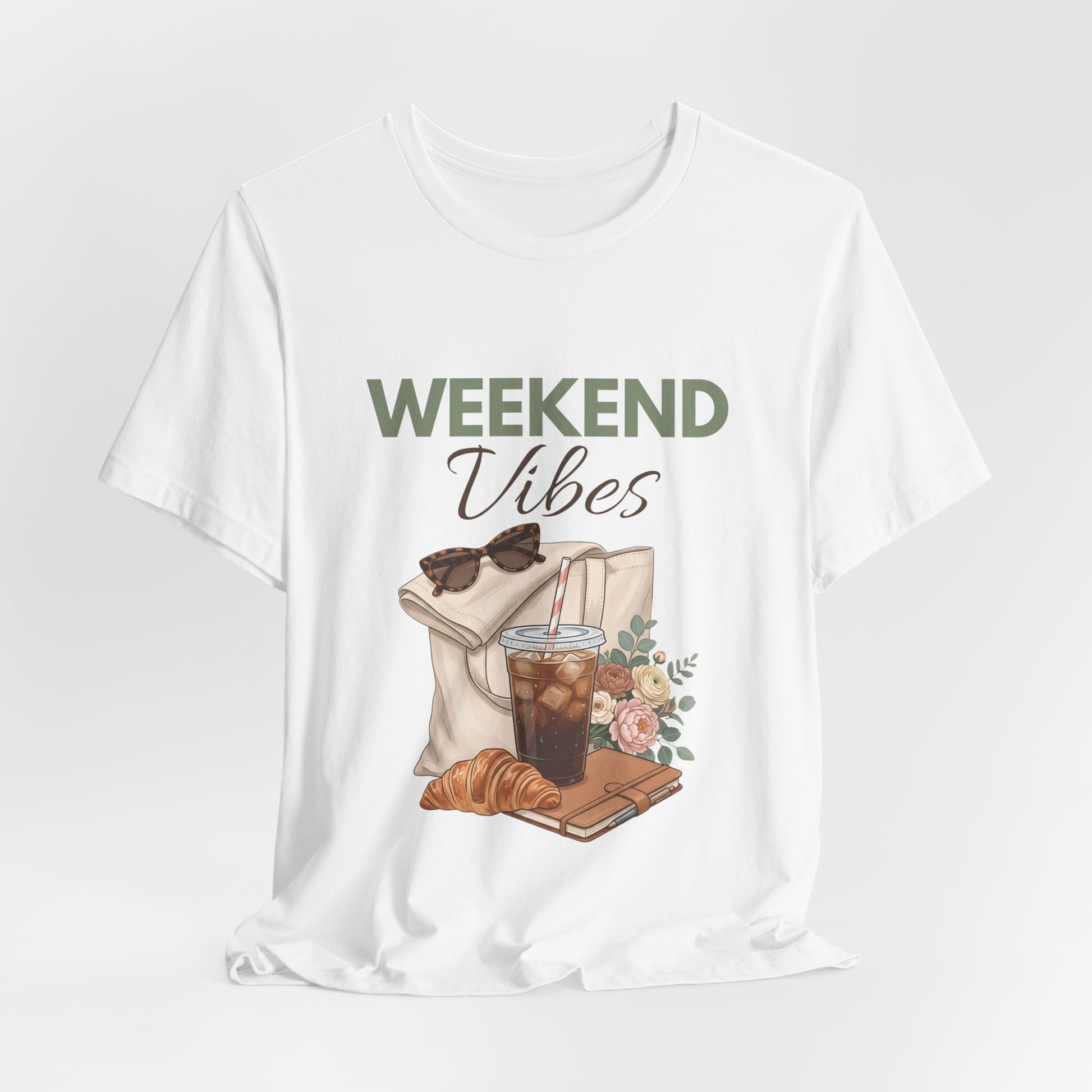 White t-shirt with 'Weekend Vibes' graphic featuring a coffee cup, croissant, and sunglasses on a white background