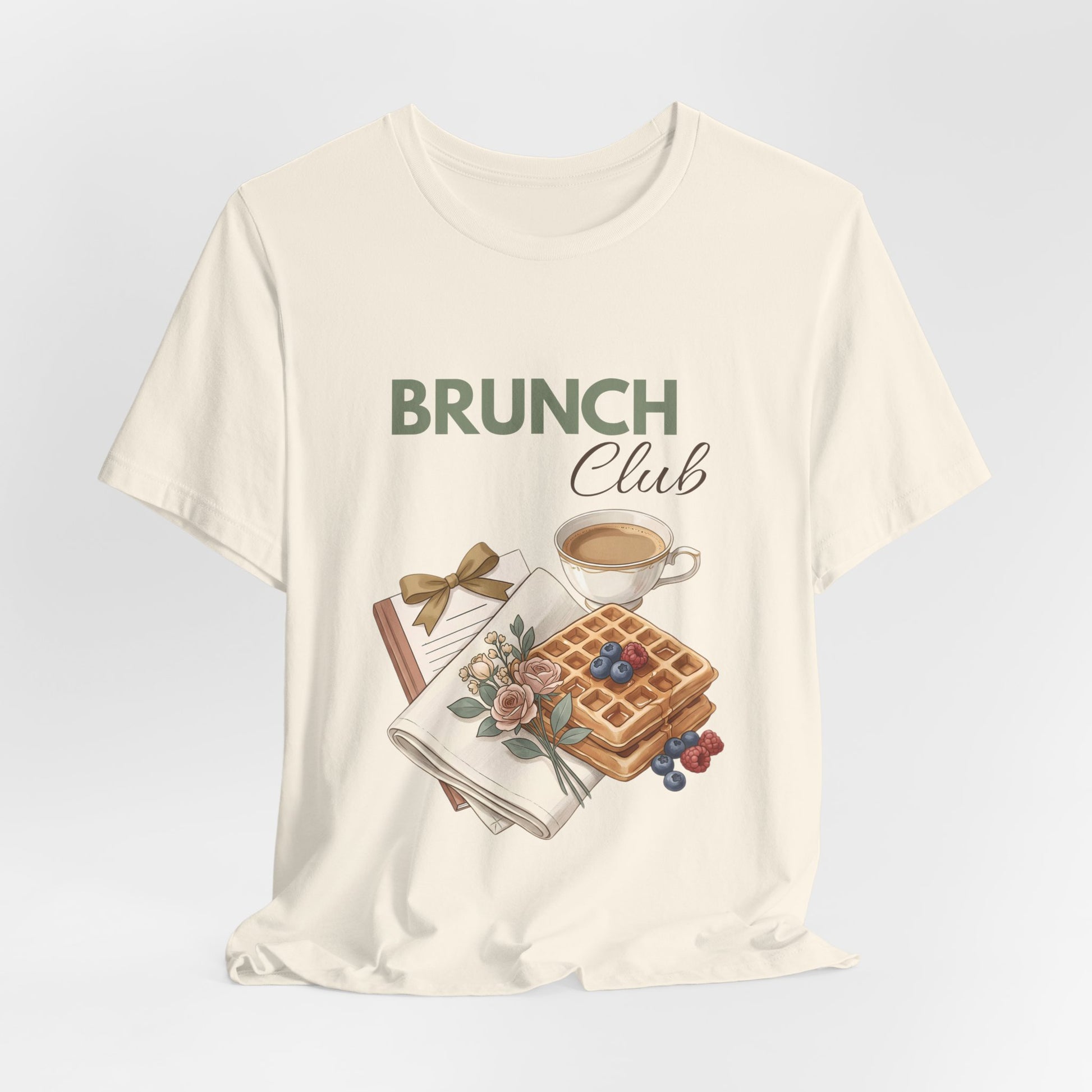 A hanging natural colored t-shirt with 'BRUNCH Club' on the front.