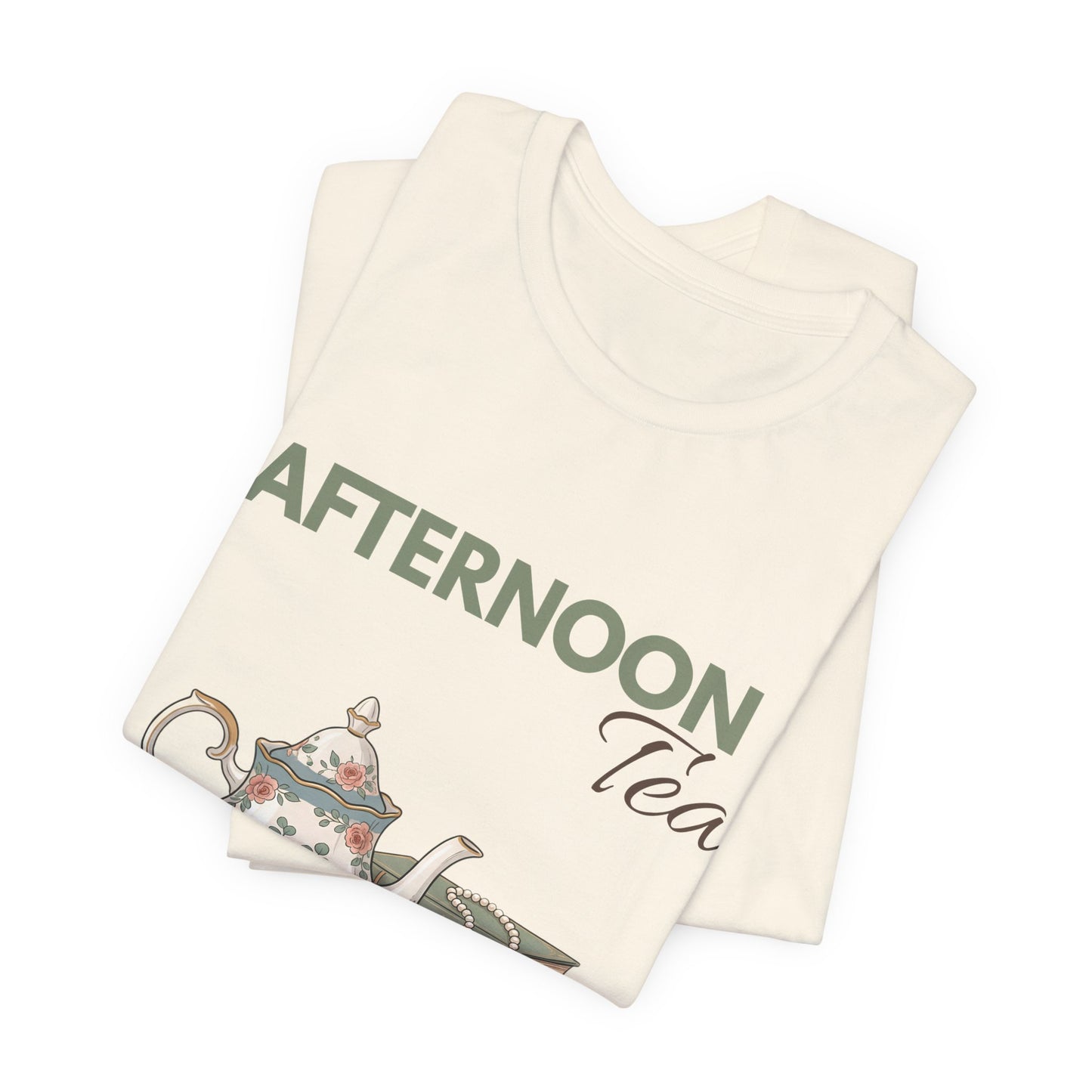 A folded natural colored t-shirt with 'AFTERNOON Tea' on the front.