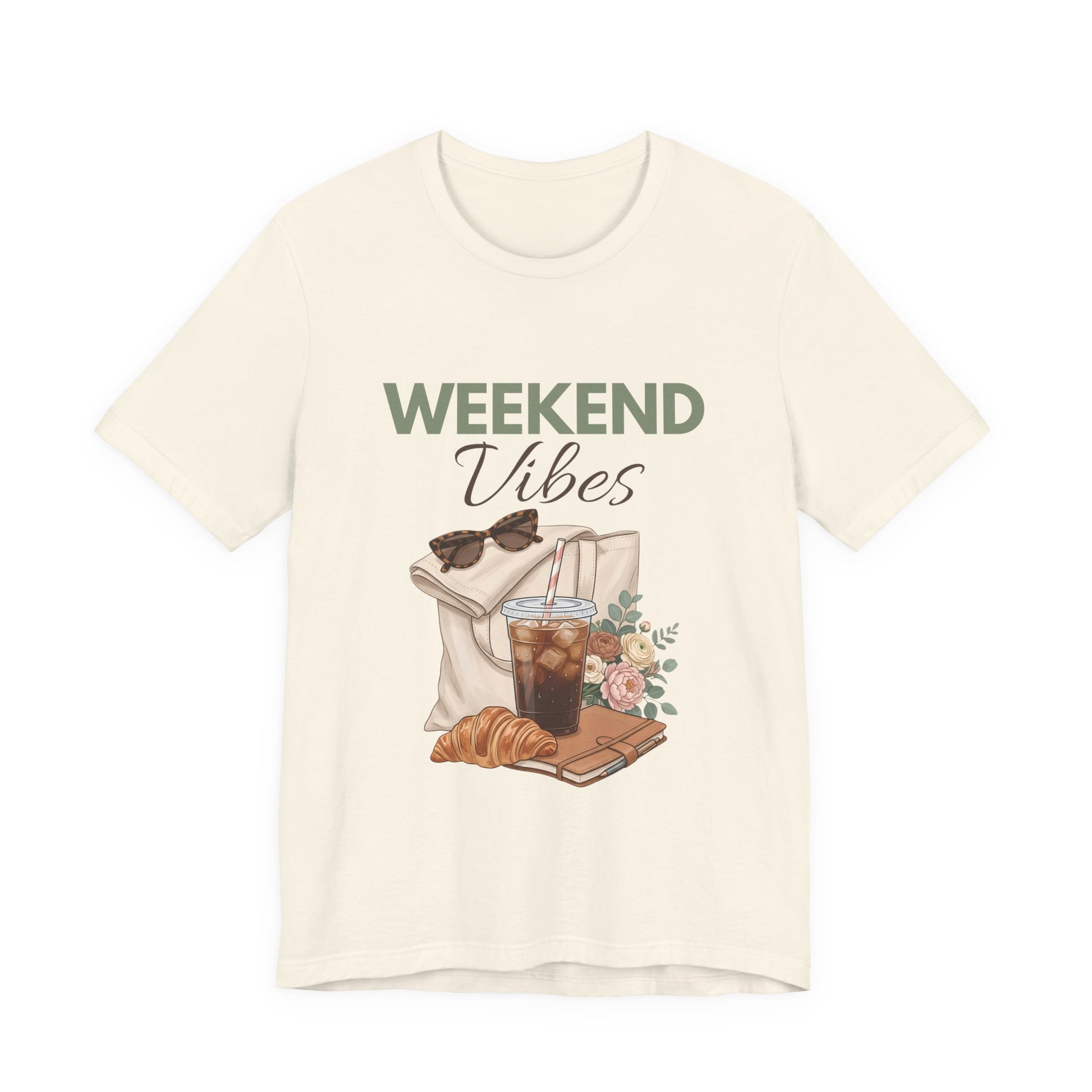 Natural colored t-shirt with 'Weekend Vibes' graphic design featuring a coffee cup, croissant, and sunglasses on a white background.