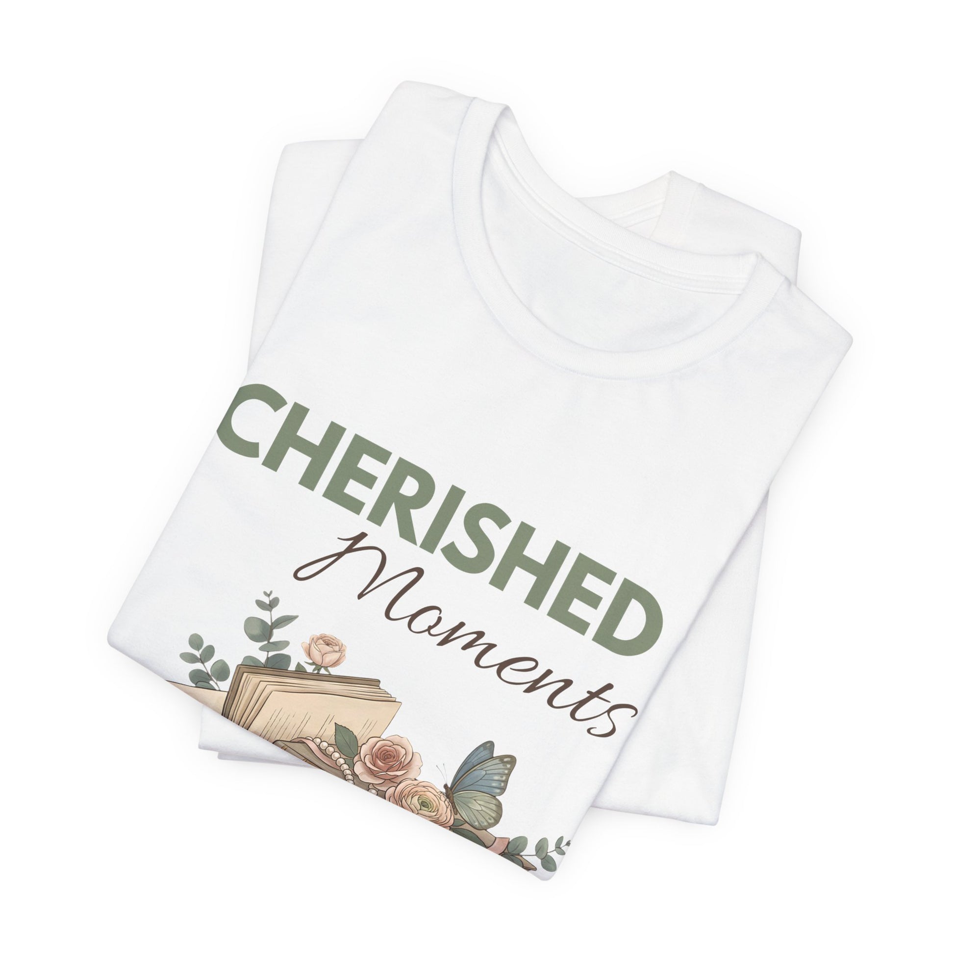 A folded t-shirt with 'CHERISHED Moments' on the front.
