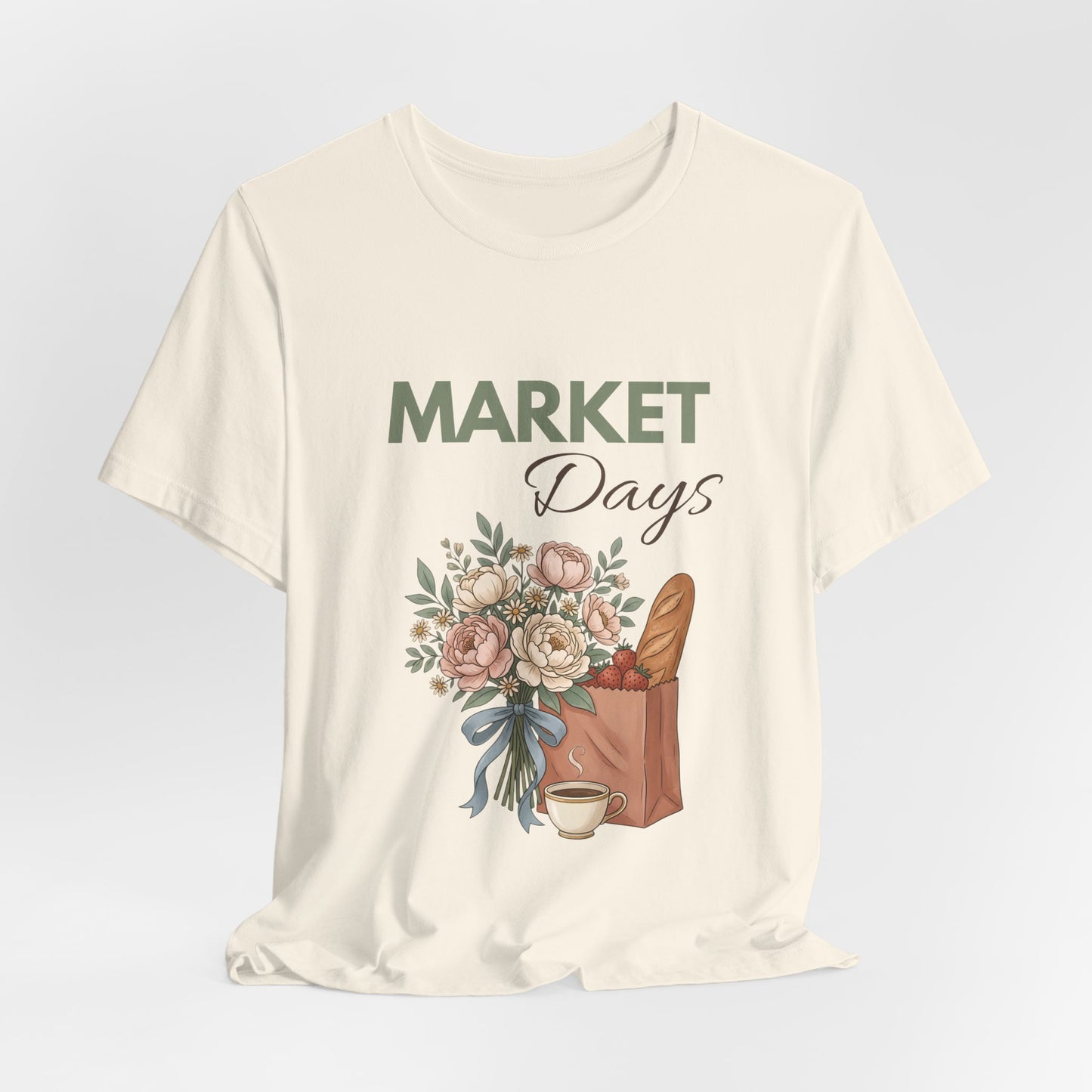 A hanging natural colored t-shirt with 'Market Days' on the front.