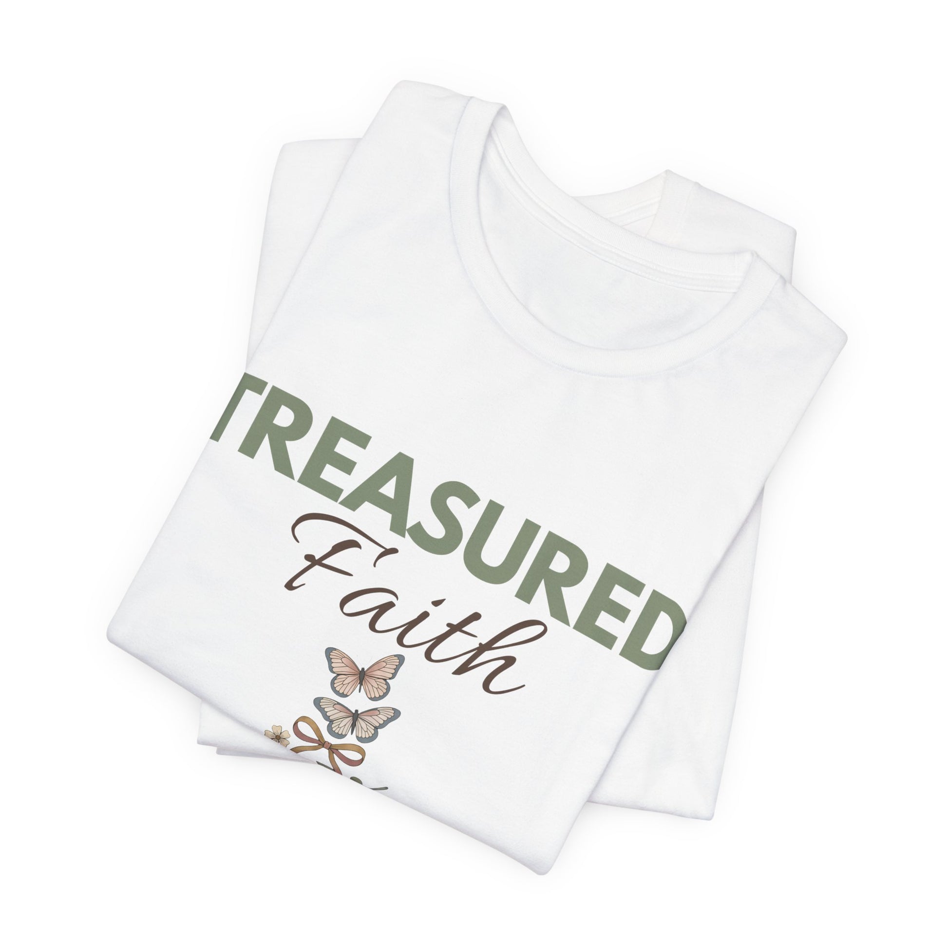 Stack of white t-shirts with 'Treasured Faith' text and butterfly design on a white background