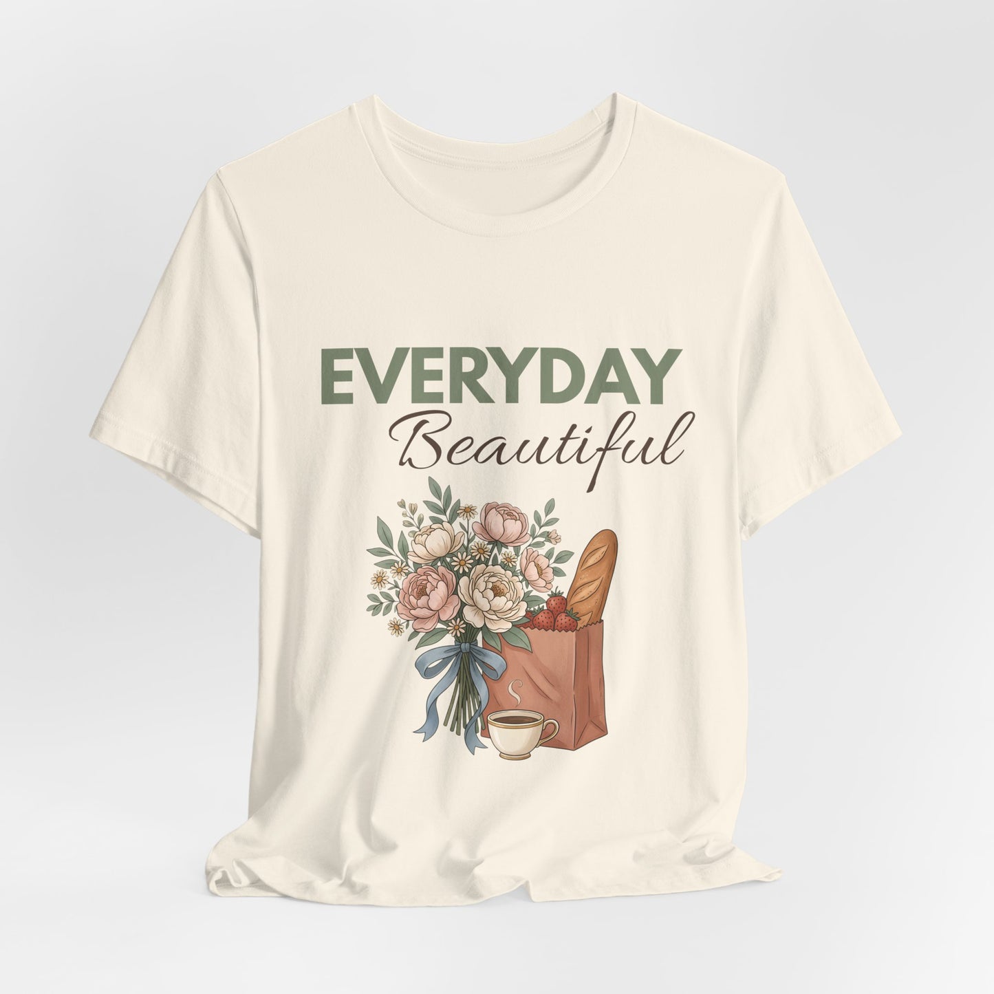 A hanging natural colored t-shirt with 'EVERYDAY Beautiful' on the front.
