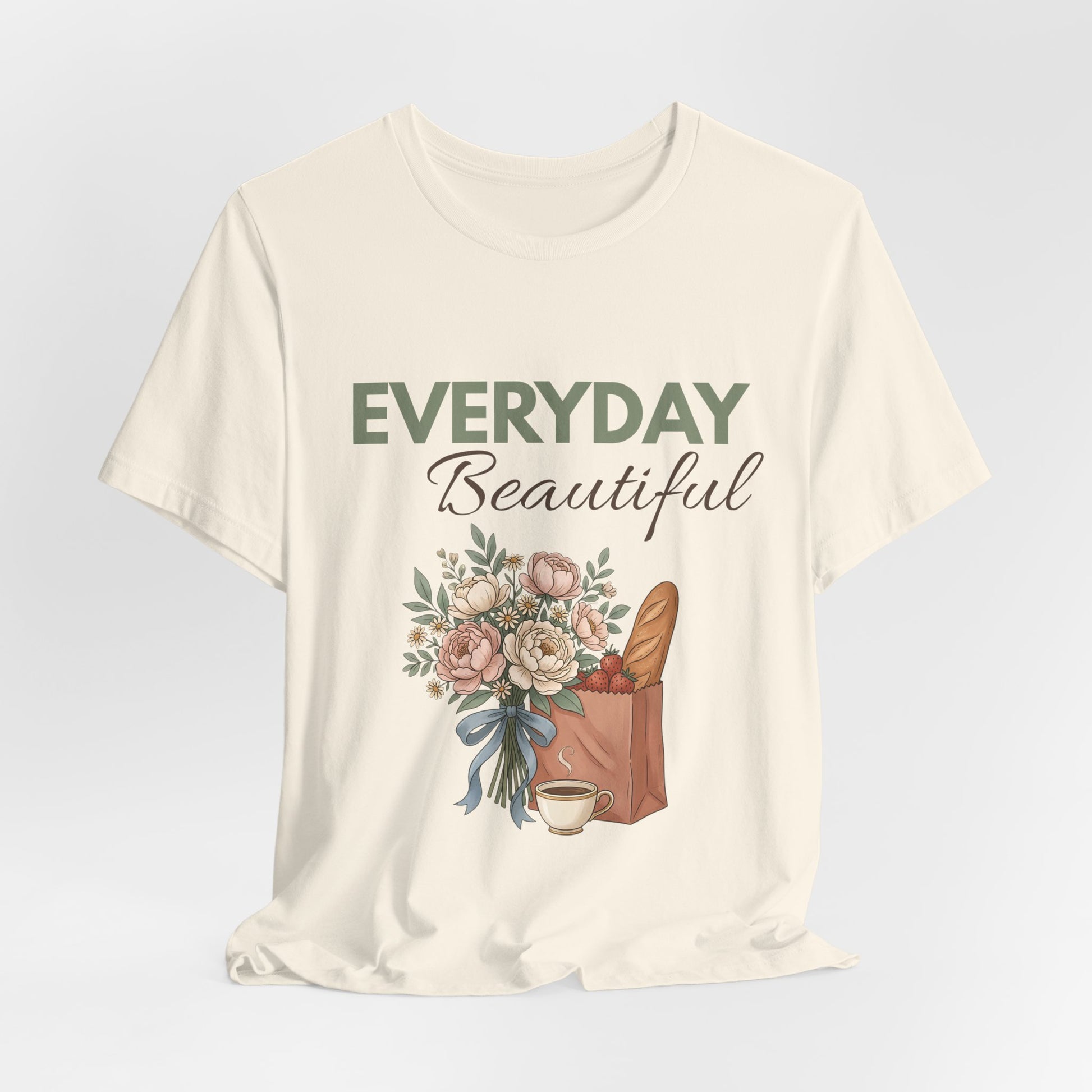A hanging natural colored t-shirt with 'EVERYDAY Beautiful' on the front.