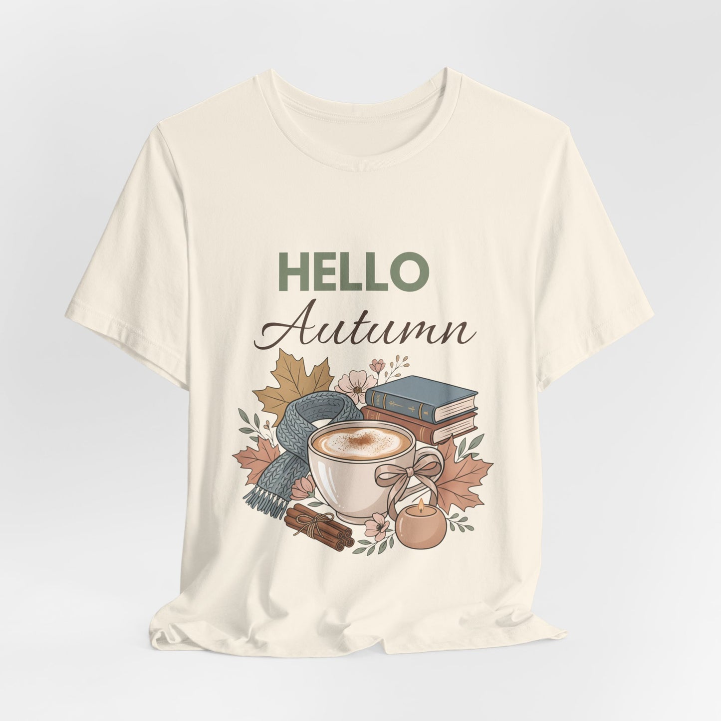 Natural colored t-shirt with 'Hello Autumn' graphic design featuring a cup, leaves, and books on a light gray background.