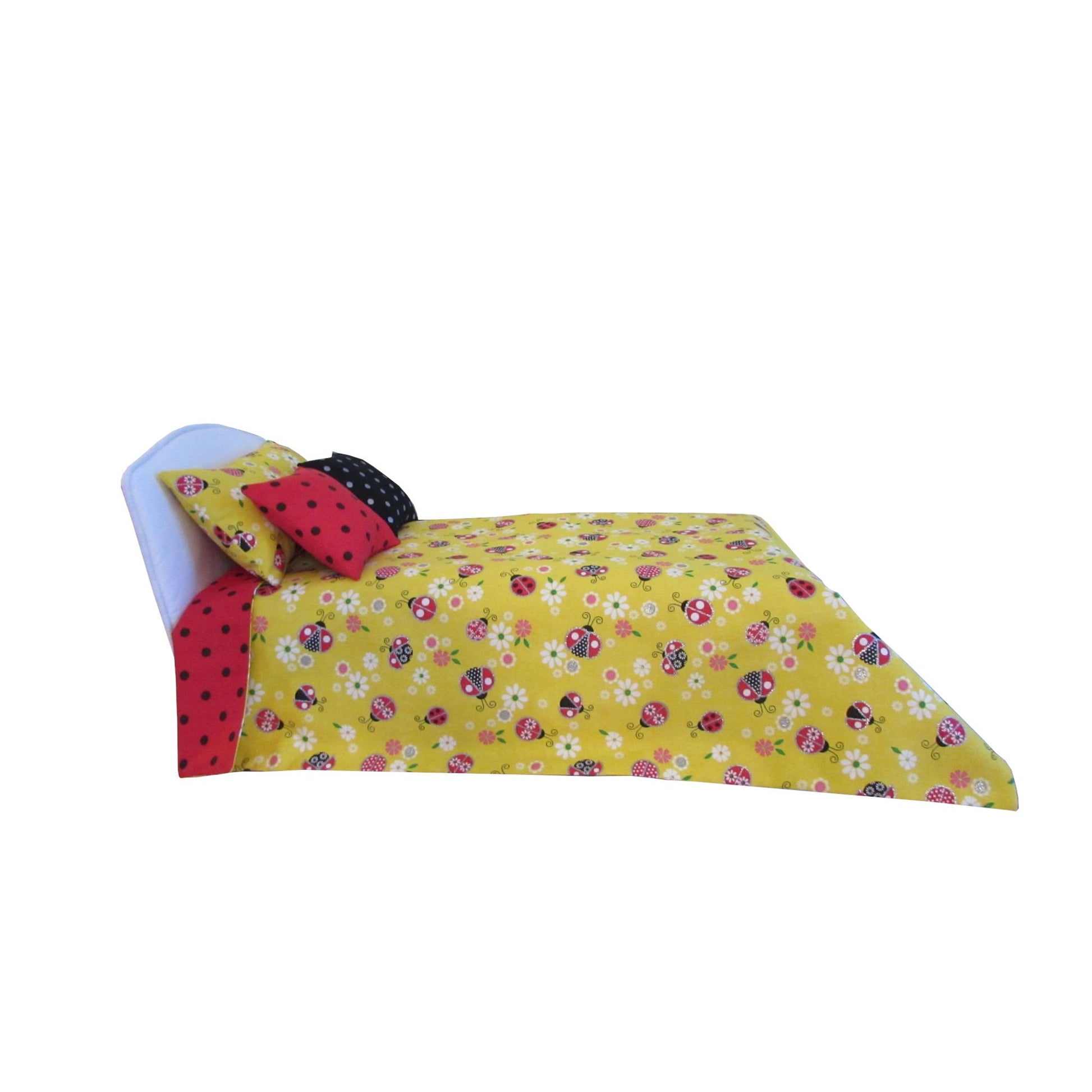 Yellow floral bedspread with red polka dot pillow on a white background