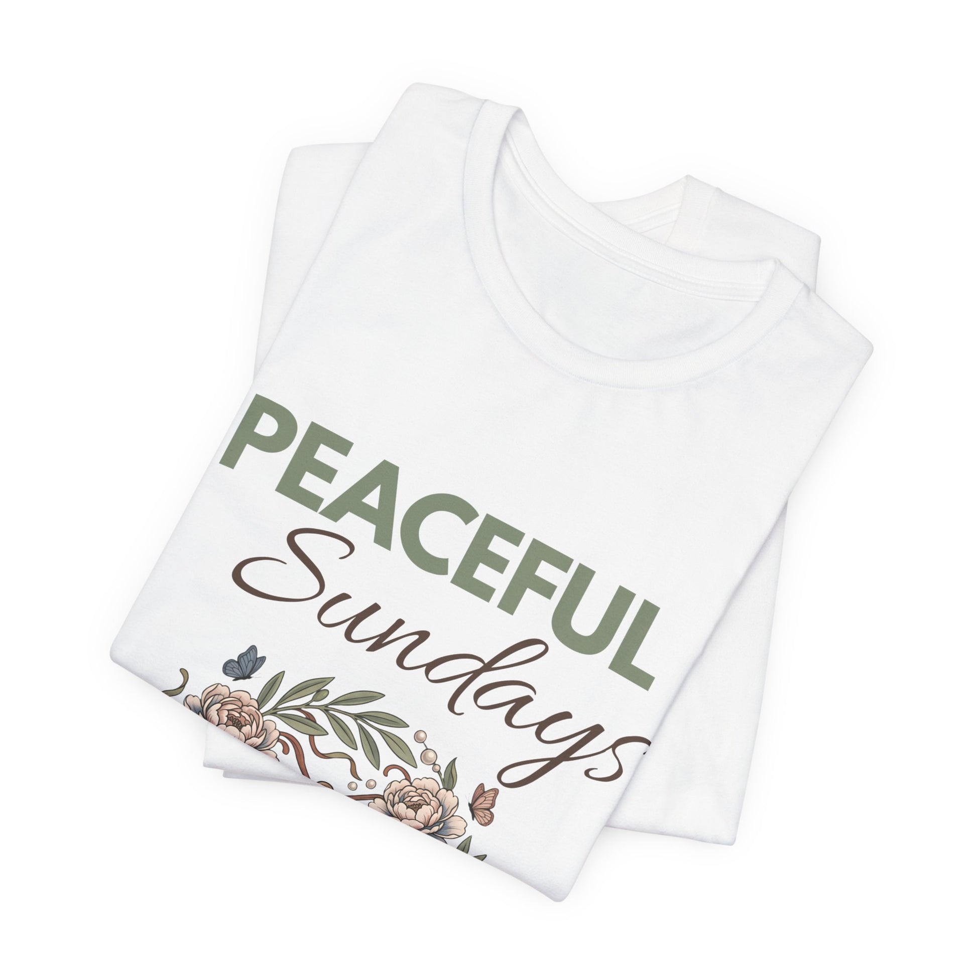 Folded white t-shirt with 'Peaceful Sundays' text and floral design on a white background