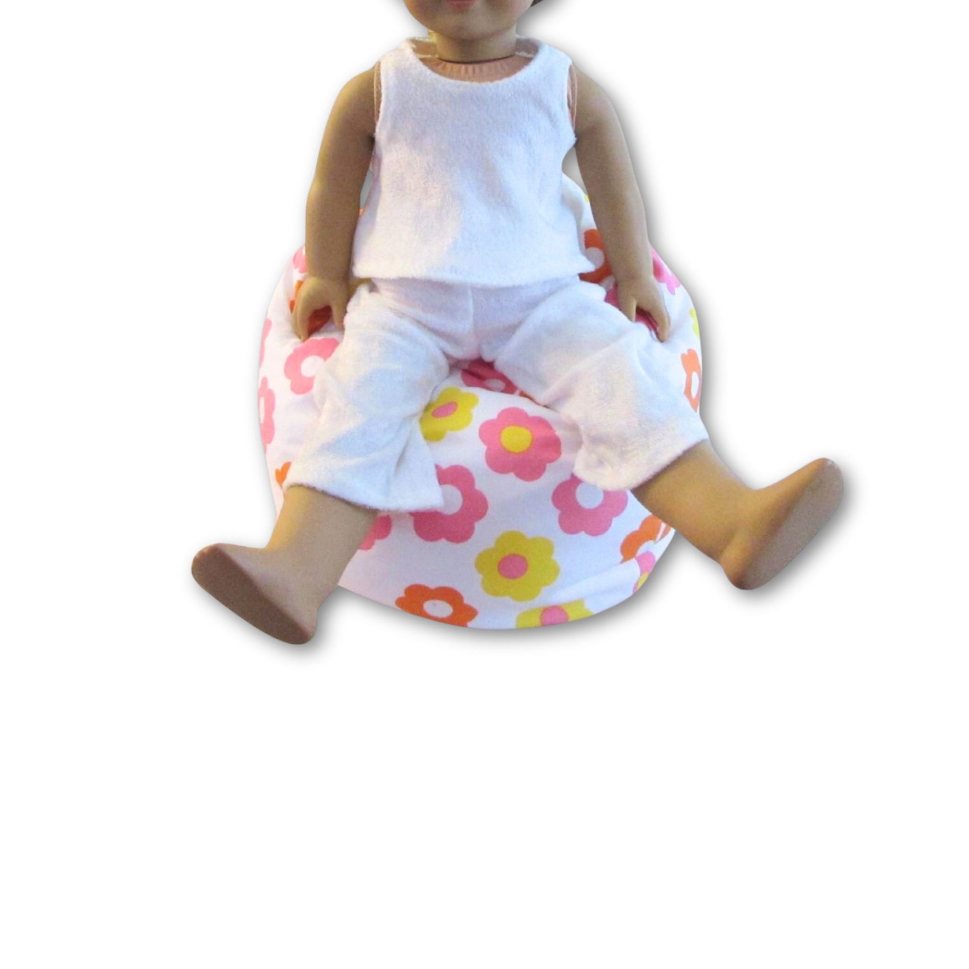Doll sitting on a floral bean bag with a white background