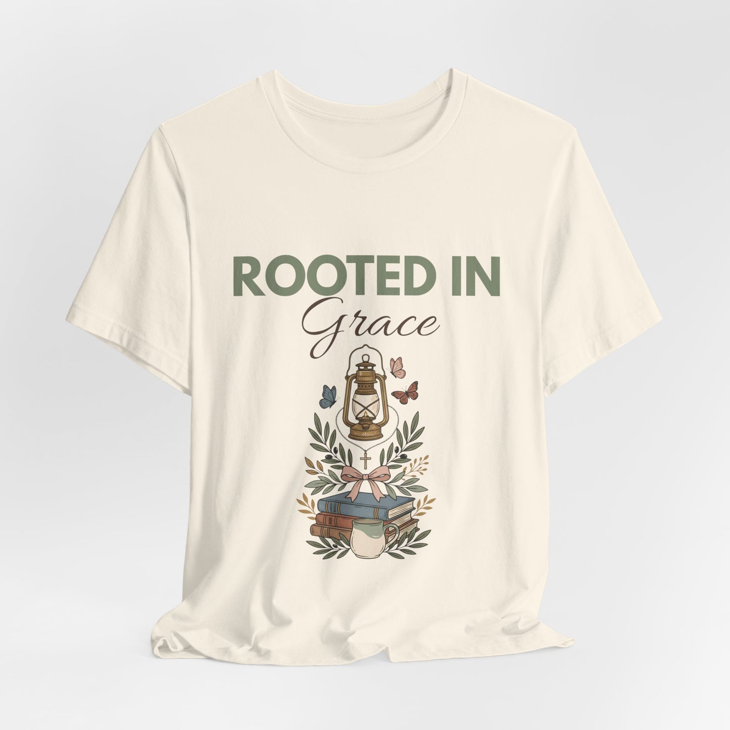 A natural colored t-shirt with 'Rooted in Grace' text and design on a light gray background