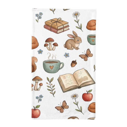 A white minky sleeping bag featuring a whimsical autumn and book-themed pattern with illustrated rabbits, mushrooms, acorns, flowers, apples, and open books.