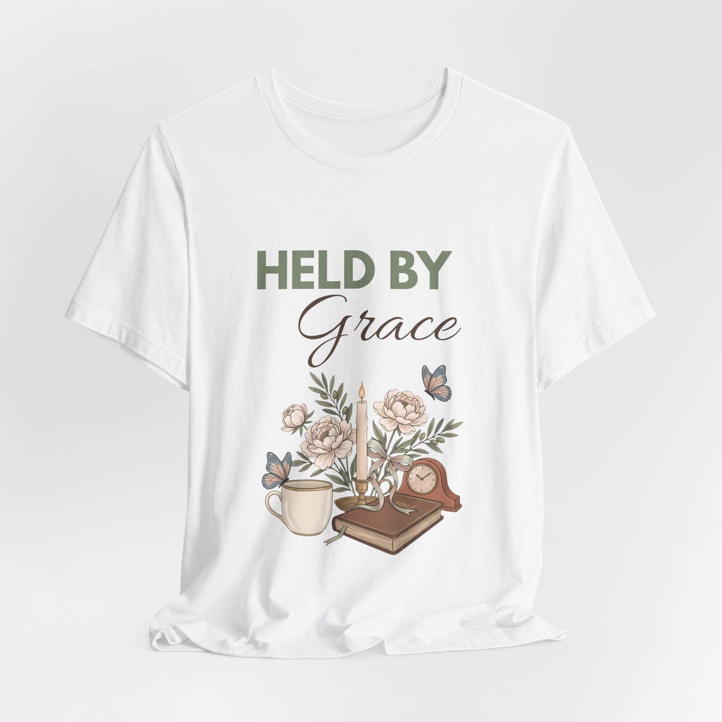 White t-shirt with 'HELD BY Grace' text and illustrations on a white background