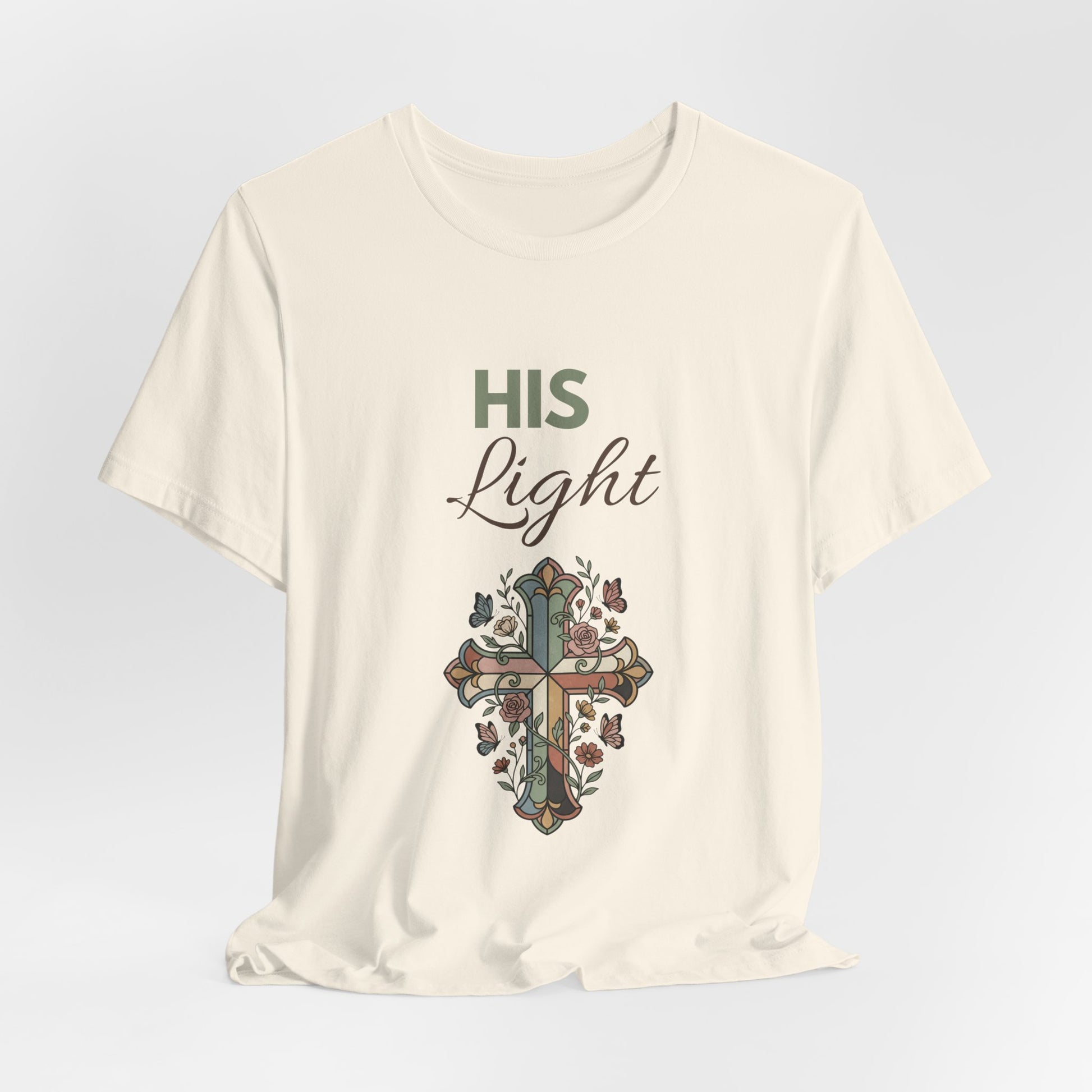 Natural colored t-shirt with a cross design and 'HIS Light' text on a light gray background