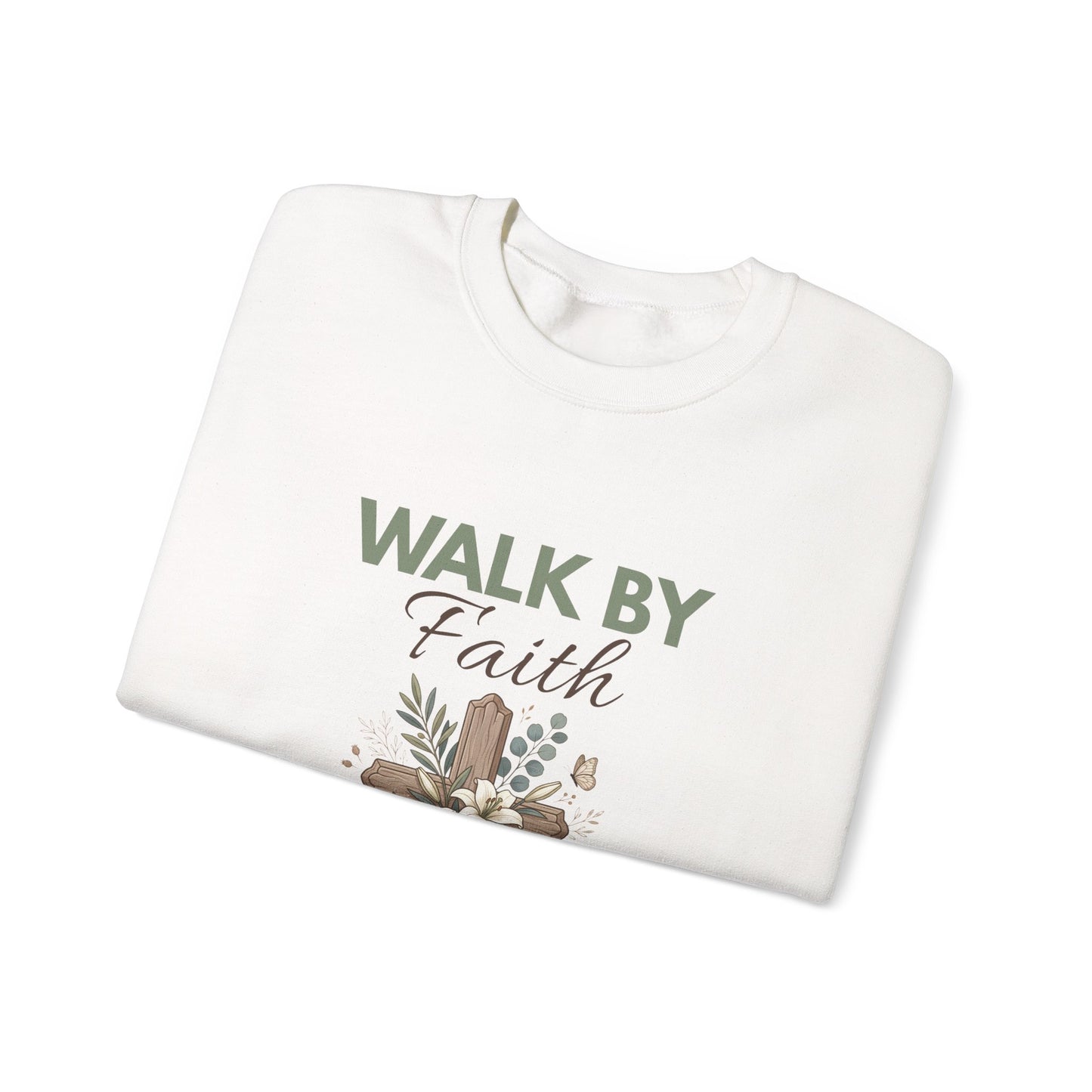 A folded white crewneck sweatshirt with 'WALK BY Faith' on the front.