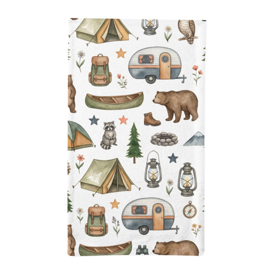 A minky sleeping bag with a white background and a repeating watercolor-style camping print, including tents, campers, lanterns, a canoe, a bear, a raccoon, a tree, stars, and flowers.