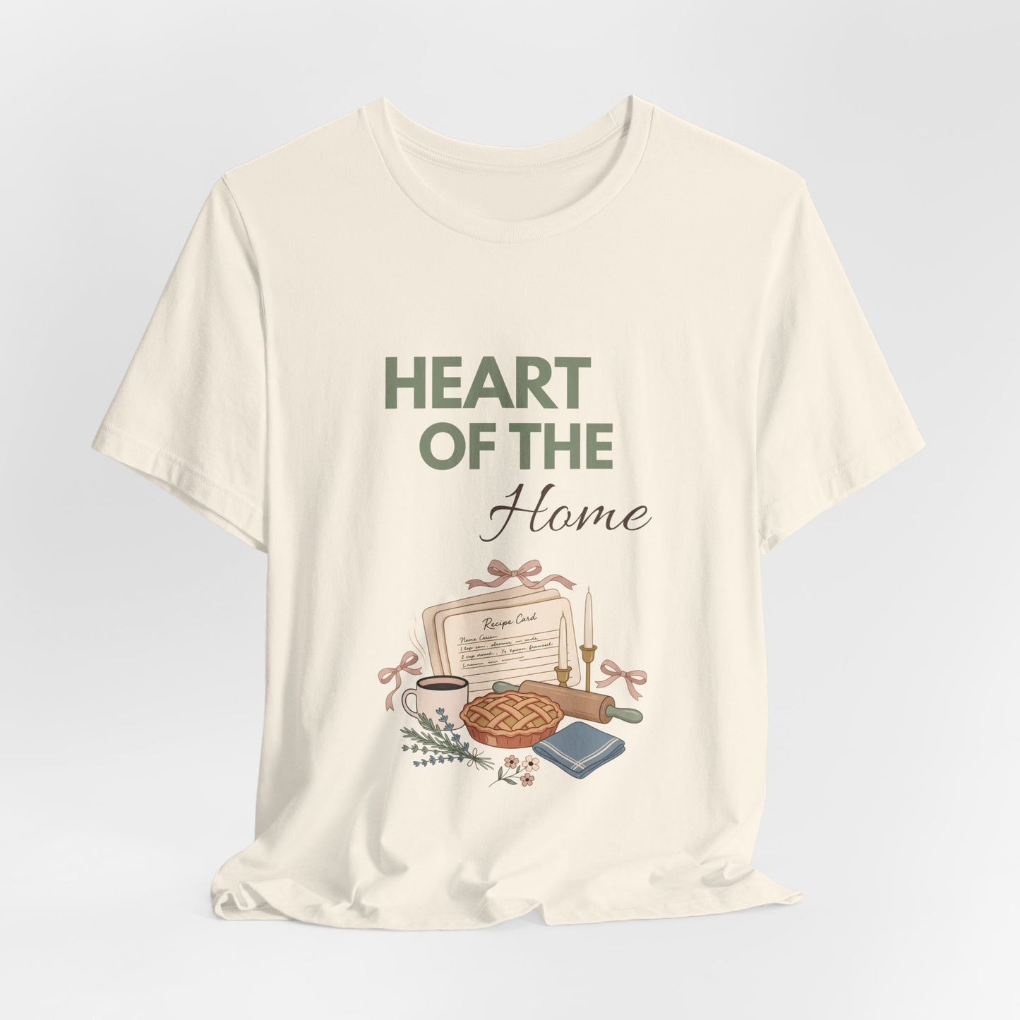 A hanging natural colored t-shirt with 'HEART OF THE Home' on the front.