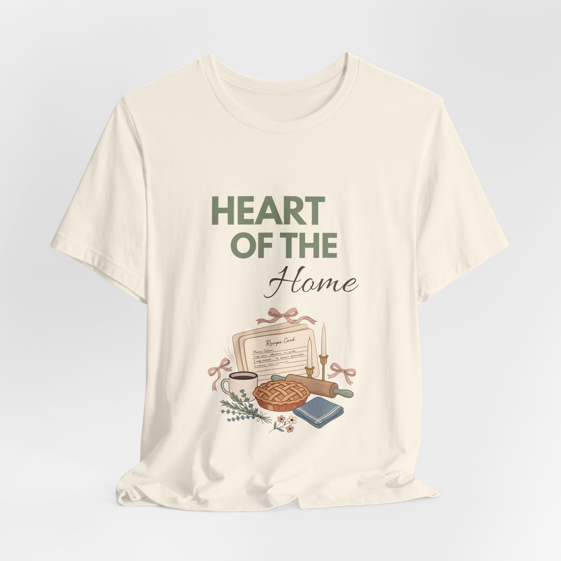 A hanging natural colored t-shirt with 'HEART OF THE Home' on the front.