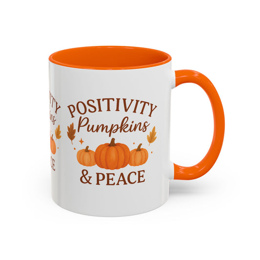 White mug with orange interior and handle, featuring pumpkins and text on a white background