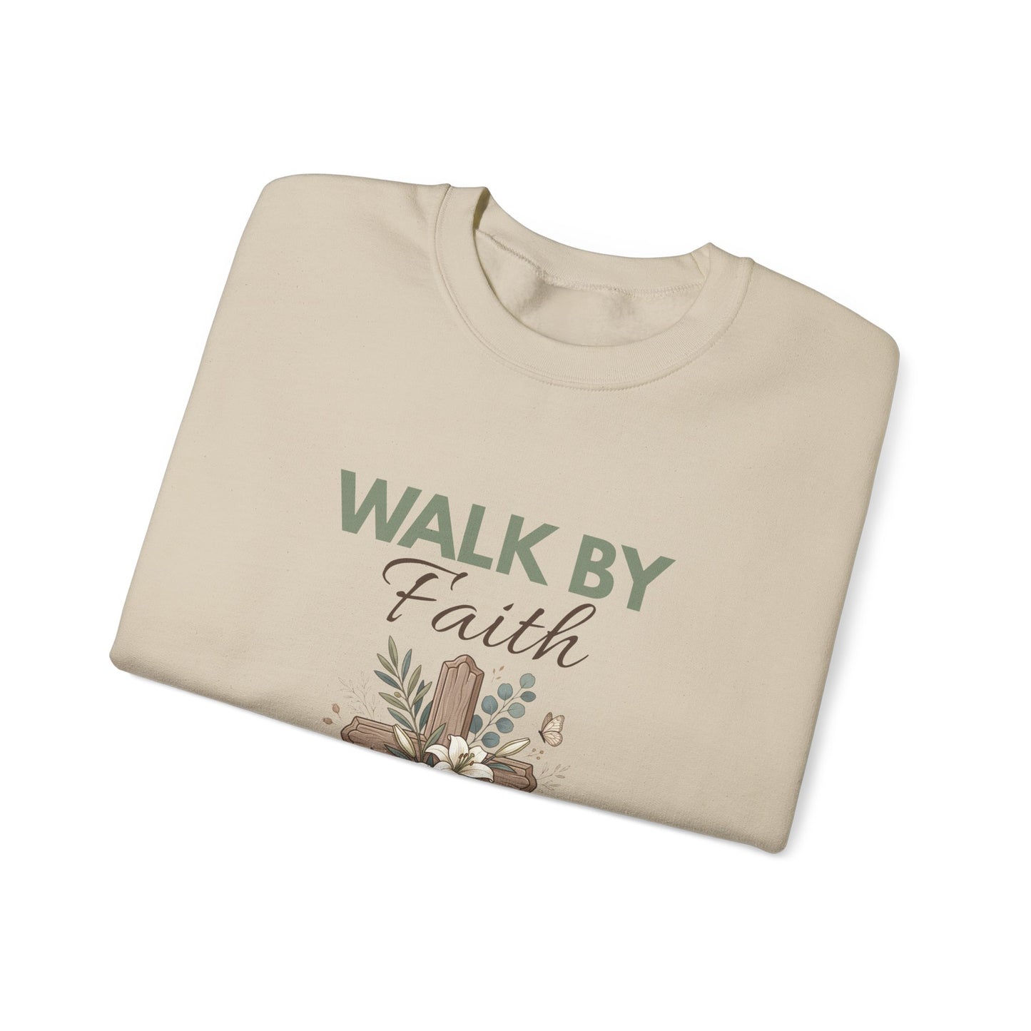 A folded sand colored crewneck sweatshirt with 'WALK BY Faith' on the front.
