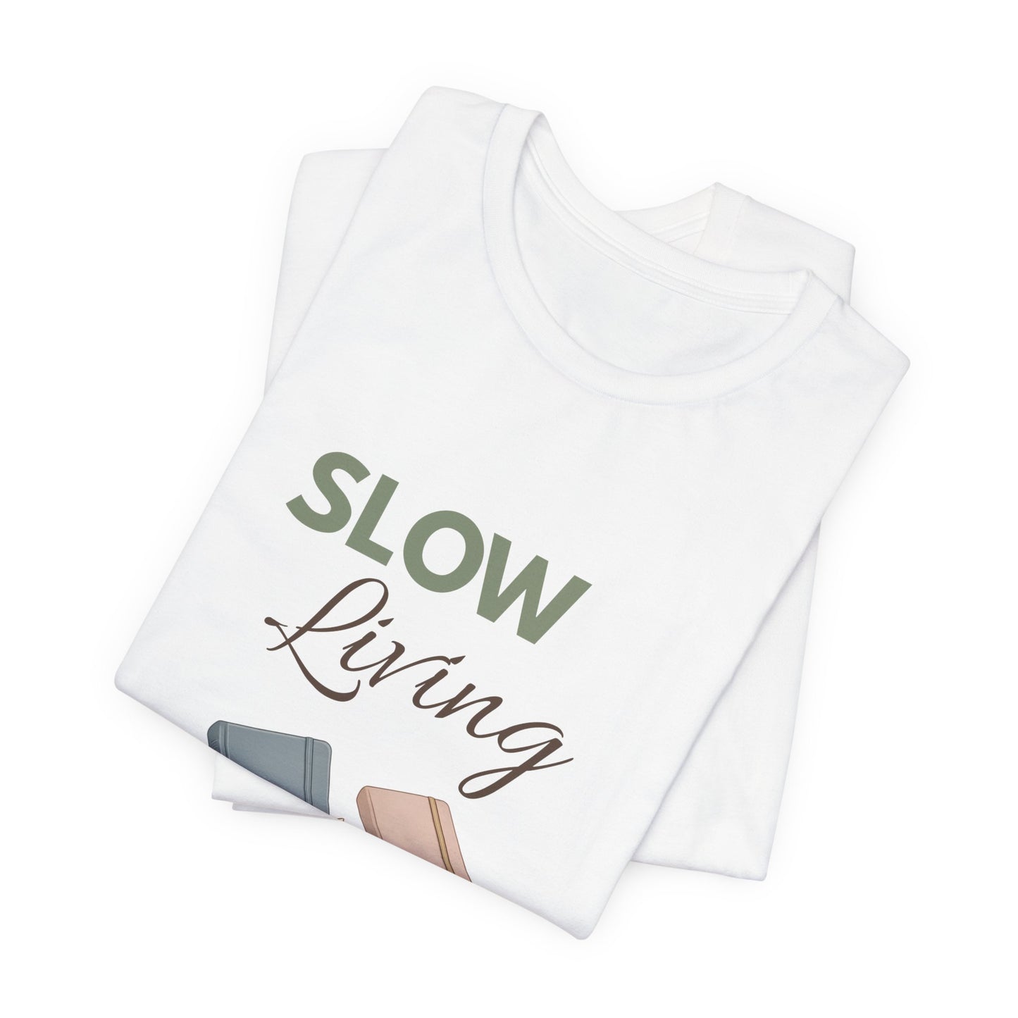 Folded white t-shirt with 'Slow Living' text and illustrations on a white background