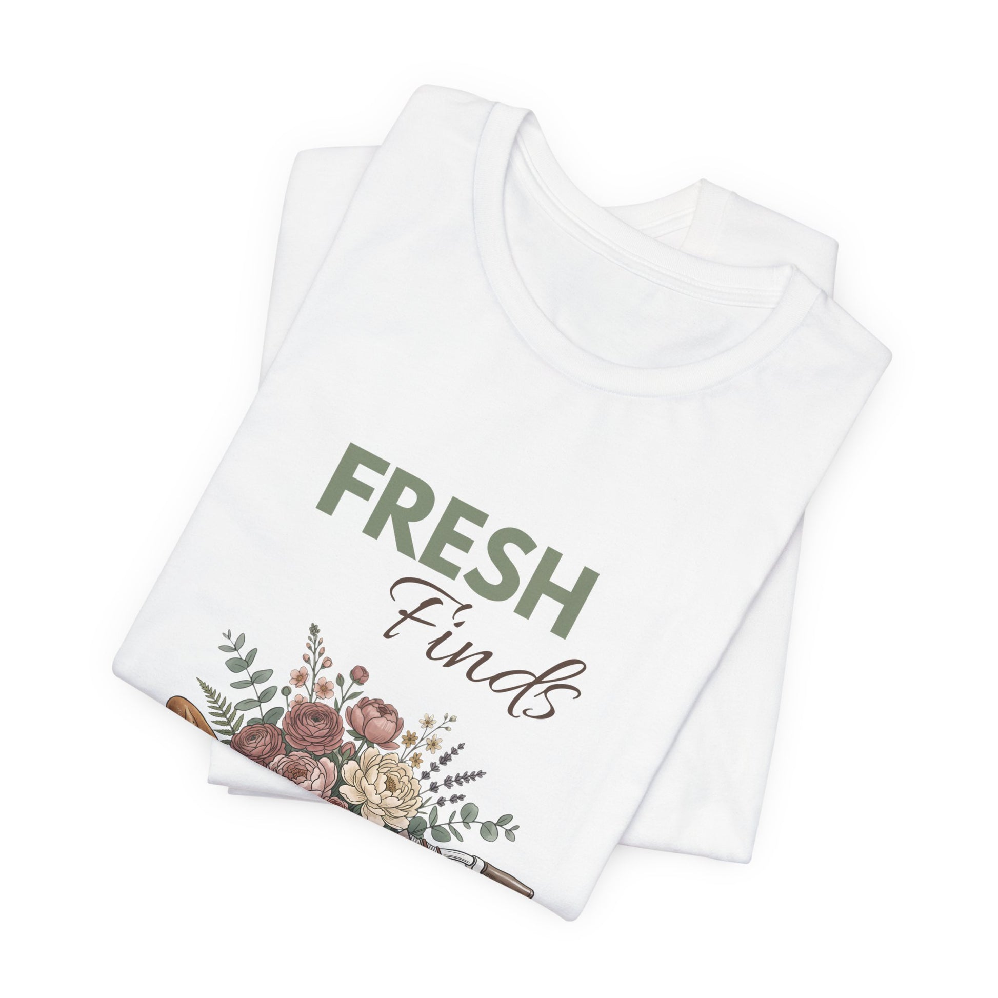 A folded white t-shirt with 'FRESH Finds' on the front.