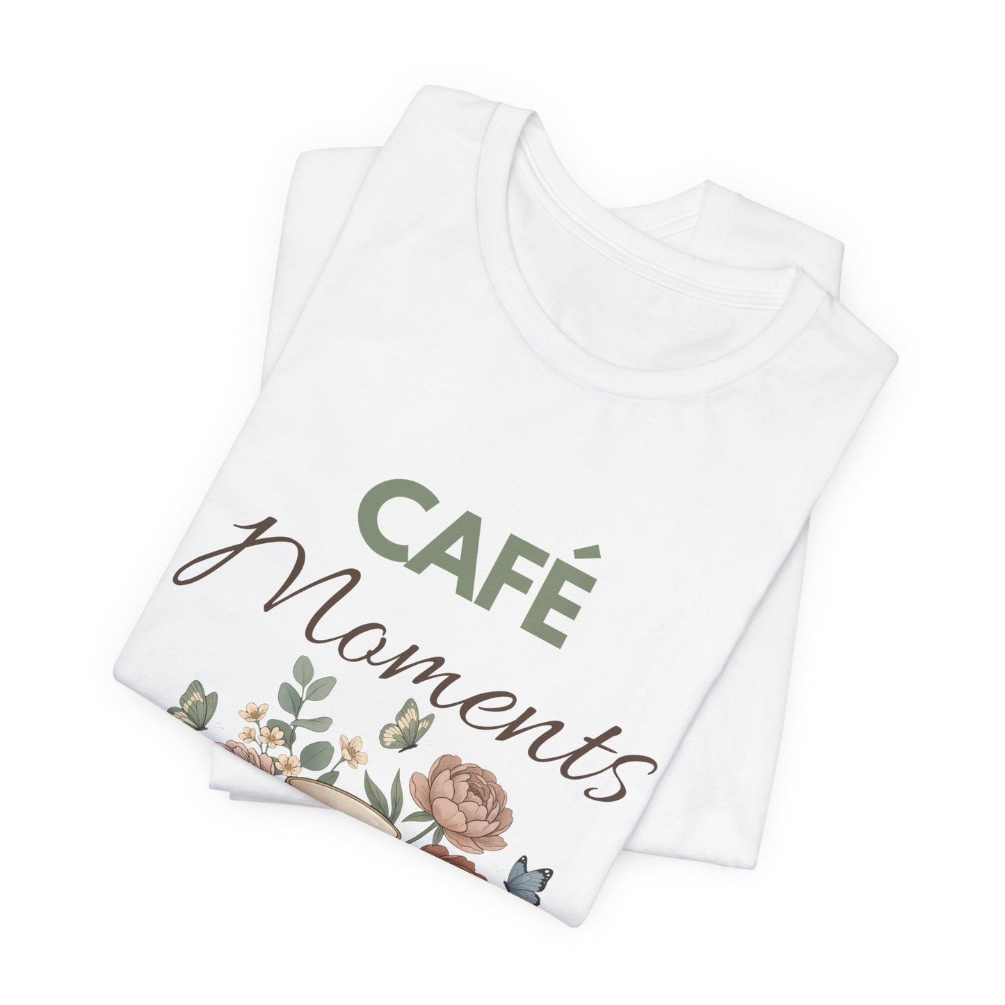 Folded white t-shirt with 'Café Moments' text and floral design on a white background