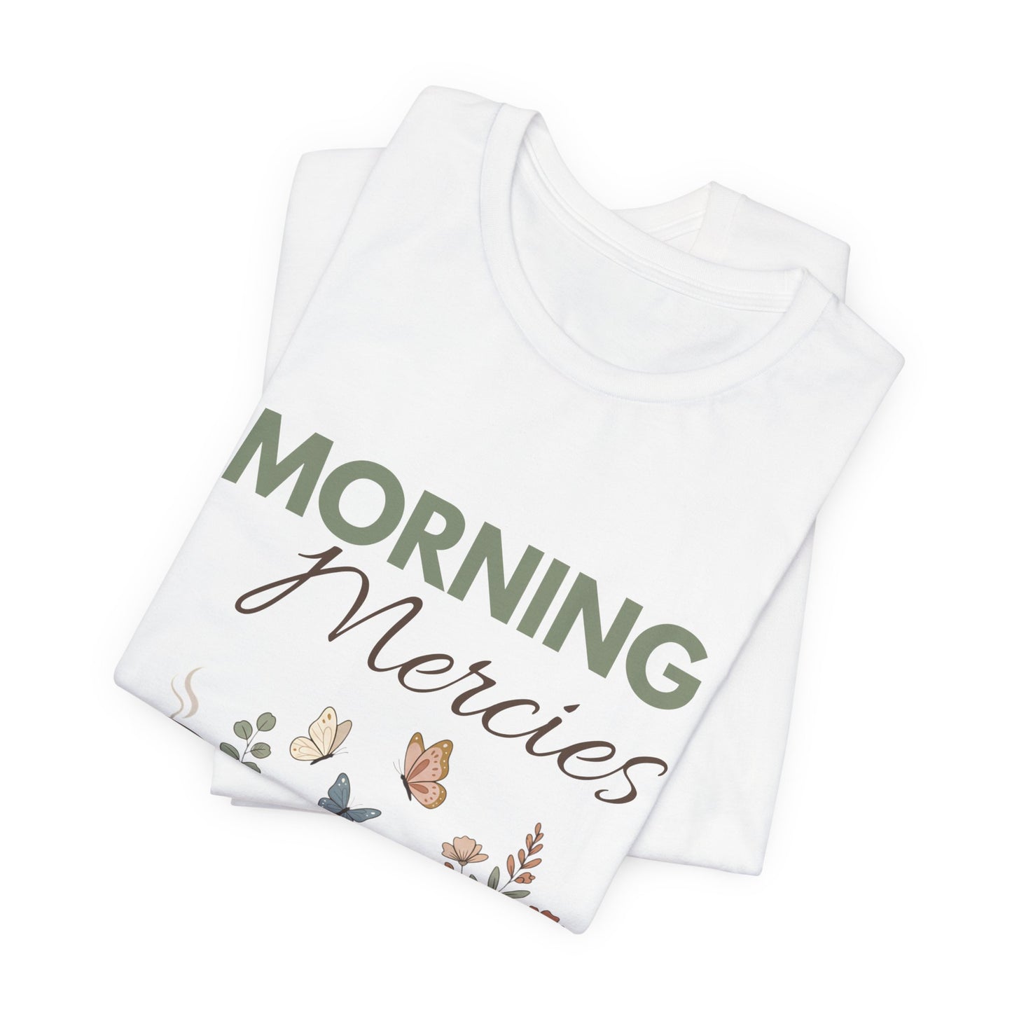 Folded white t-shirt with 'Morning Mercies' text and floral designs on a white background