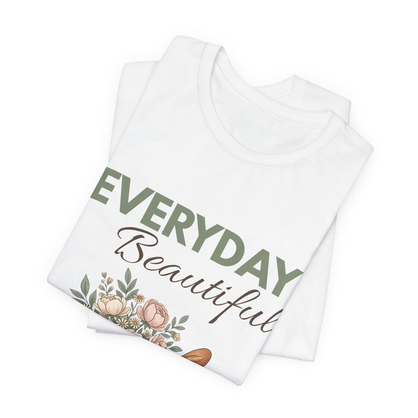 A folded white t-shirt with 'EVERYDAY Beautiful' on the front.
