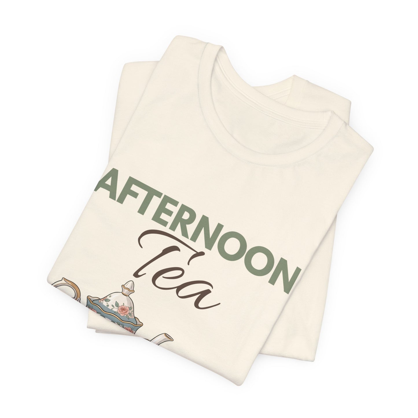 A folded natural colored t-shirt with 'AFTERNOON Tea' on the front.