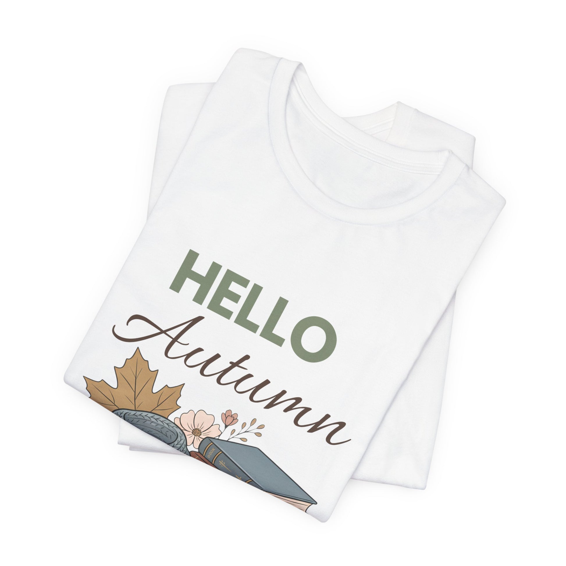 Folded white t-shirt with 'Hello Autumn' text and leaf design on a white background