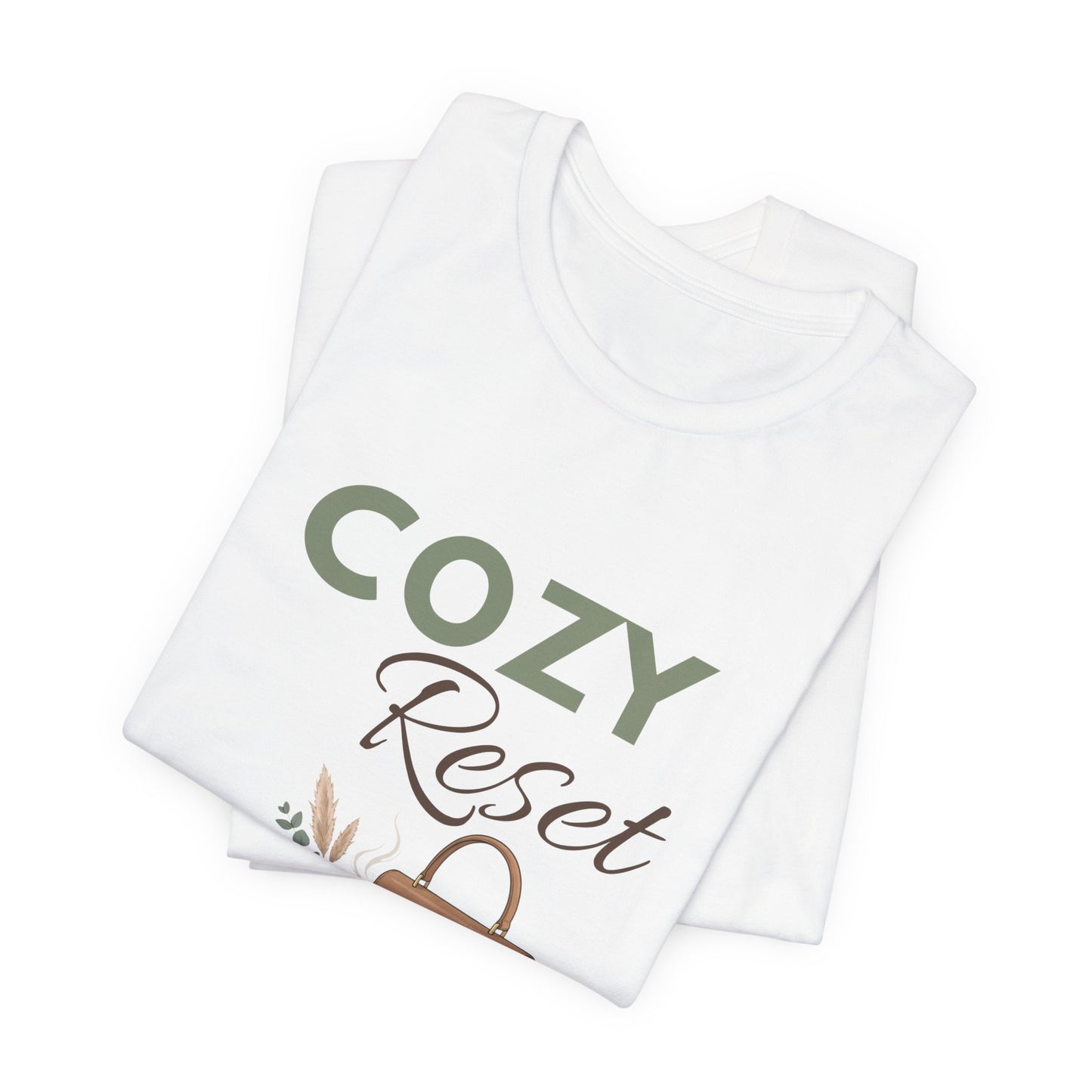 A folded white t-shirt with 'COZY Reset' on the front.